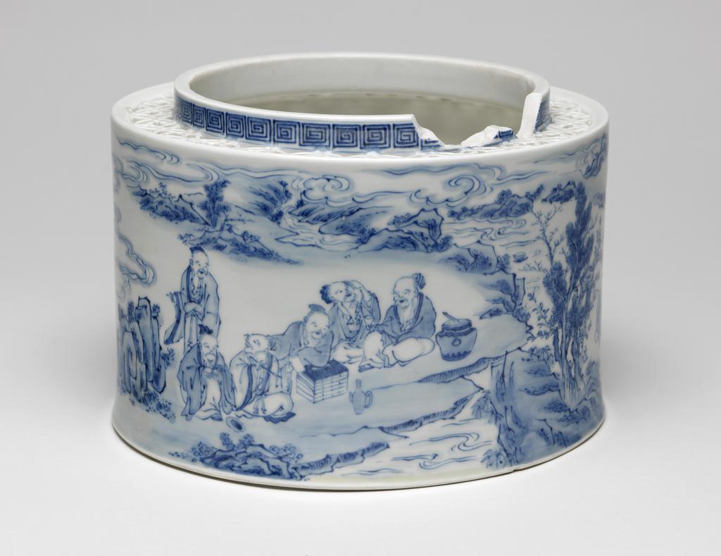 An image of Cover. Arita Factory, Japan. Blue and white openwork hard paste porcelain cover (the base and top are missing). Decorated with a famous scene of a Chinese literati gathering, with wine cups floating down stream. 1810- 1840. Edo Period (1615-1868). Acquisition Credit: Given by David Hyatt King, through The Art Fund.