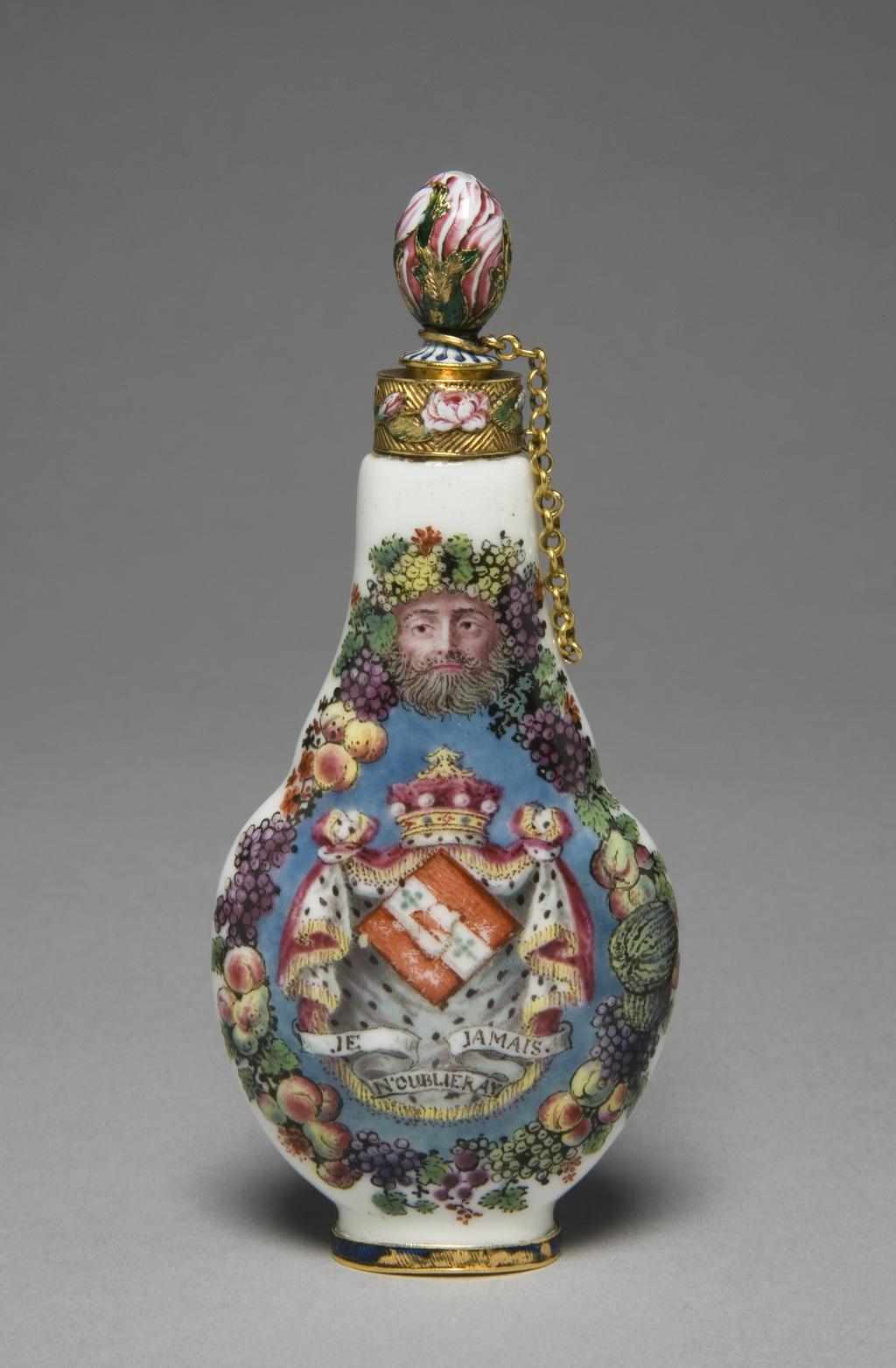 An image of Scent Flask. Capodimonte Porcelain Factory. Soft-paste porcelain, moulded, painted overglaze in enamels with gold mounts. Stopper, attached by a chain, is engraved and decorated in enamels. Height 10.6cm, width 4.7cm, depth 2.5cm, circa 1752-1755, the mounts are circa 1755-1760. Decorated on one side with a portrait of Prince Charles Stuart, the Young pretender (1720-88), and on the other with the arms of Lady Mary Hervey (1700-68), widow of John, Lord Hervey of Ickworth. Capodimonte, with London mounts.