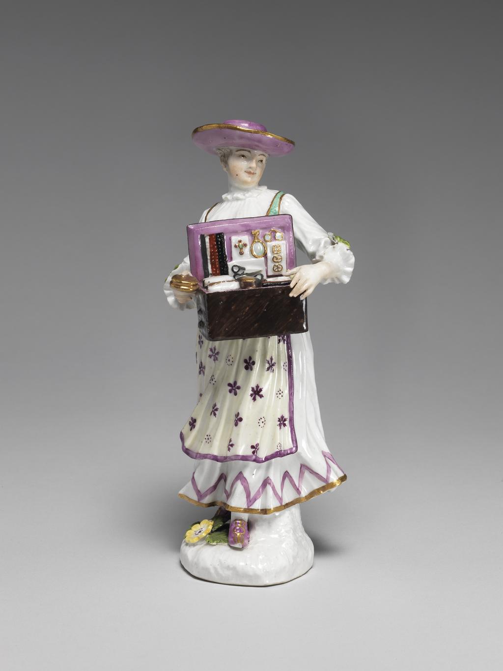 An image of Figure. A Tyrolian Woman selling Trinkets. Meissen Porcelain Manufactory, Saxony. Hard-paste porcelain painted in enamels.