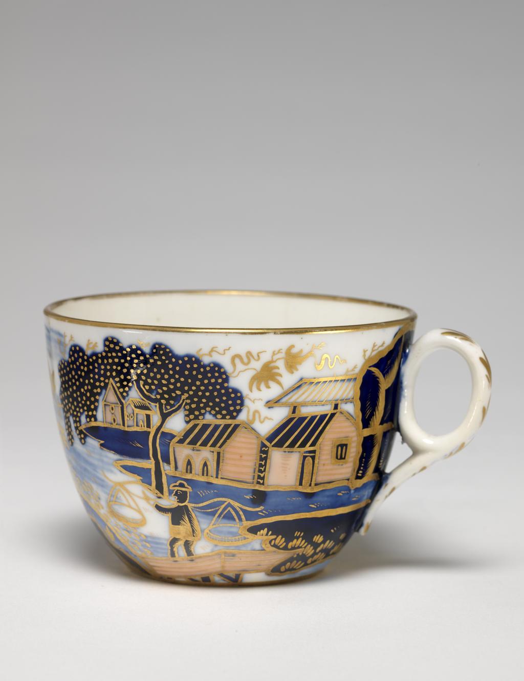 An image of Cup and Saucer/Teacup. New Hall Porcelain Factory, Staffordshire. The cup is of Bute shape with oval ring handle. The saucer is circular with curved sides, standing on a footring. The cup is decorated on the exterior with an Oriental landscape with buildings on the left and right, a man standing fishing on a bridge, a man in a boat, and a larger man in the middle. Inside below the rim there is a continuous horizontal spray of leaves in gold. There is a gold band round the rim, and six stylized leaves down the back of the handle. The interior of the saucer is decorated to match the exterior of the cup and has a gold band round the rim. Pattern 1163. Bone china, painted underglaze in blue, overglaze in apricot-pink enamel, and gilded. Height, cup, 6 cm, width, cup, 10.5 cm, diameter, cup, 8.5 cm, height, saucer, 3.5 cm, diameter, saucer, 14.5 cm, circa 1815-1820. Imari style.