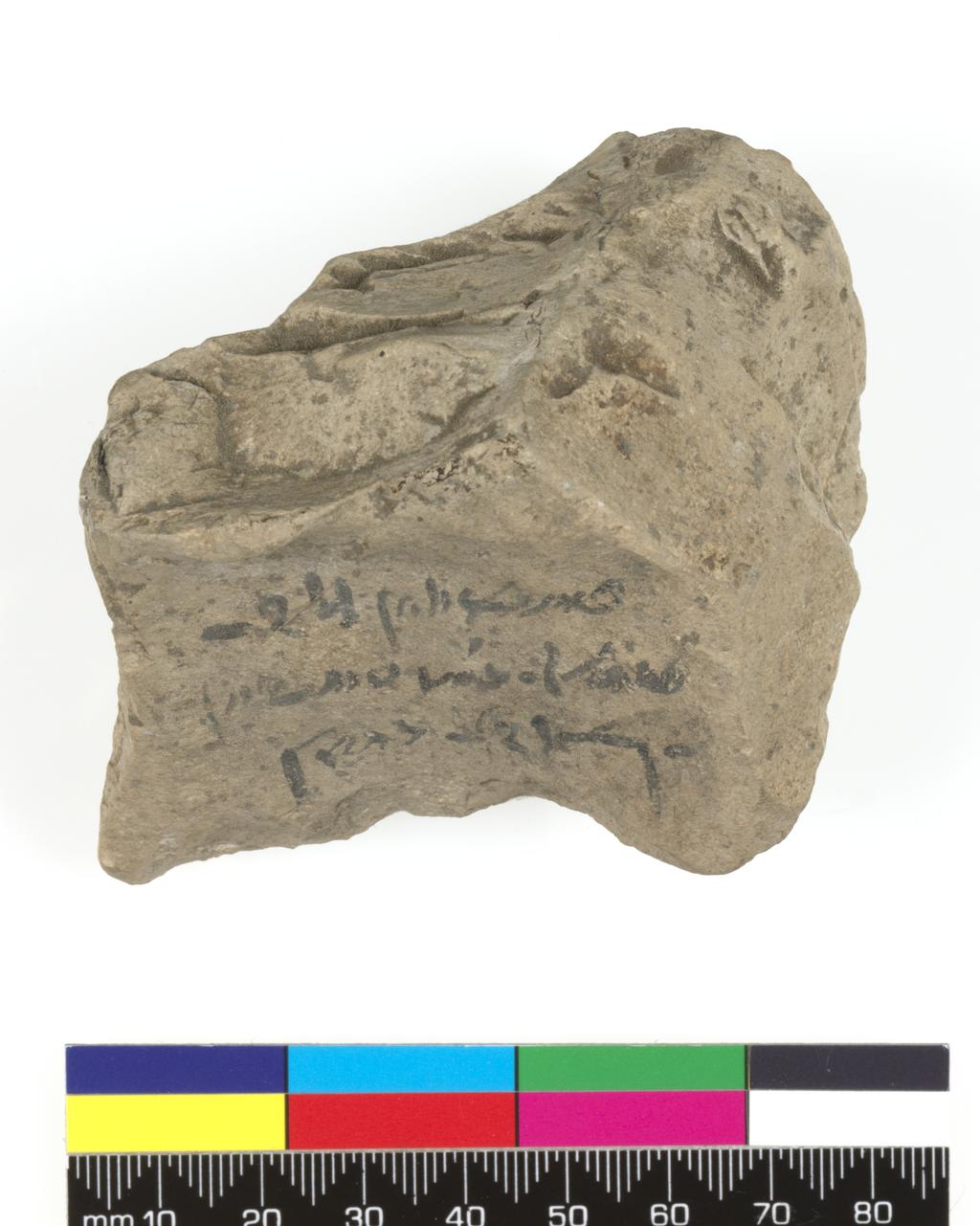 An image of Written document/Ostracon. Inscribed in black ink, demotic short order. Production Place/Find Spot: Egypt. Limestone, depth 0.048 m, length 0.071 m, width 0.06 m. Ptolemaic Period.