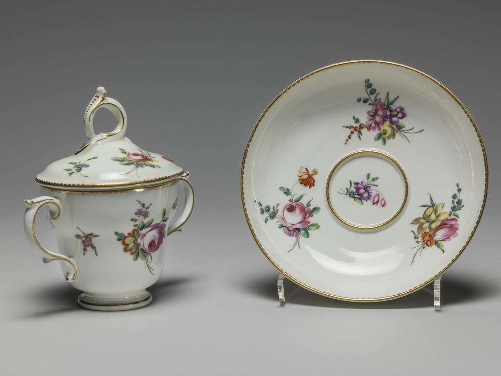 An image of Chocolate cup with cover and saucer. Chelsea-Derby Porcelain Factory. Soft-paste porcelain, decorated with flowers in polychrome onglaze enamels, height, cup and cover, 5 1/4 in, width, cup and cover, 5 in, height, saucer, 1 1/2 in, diameter, saucer, 5 3/4, in, circa 1775. Chelsea-Derby Period.