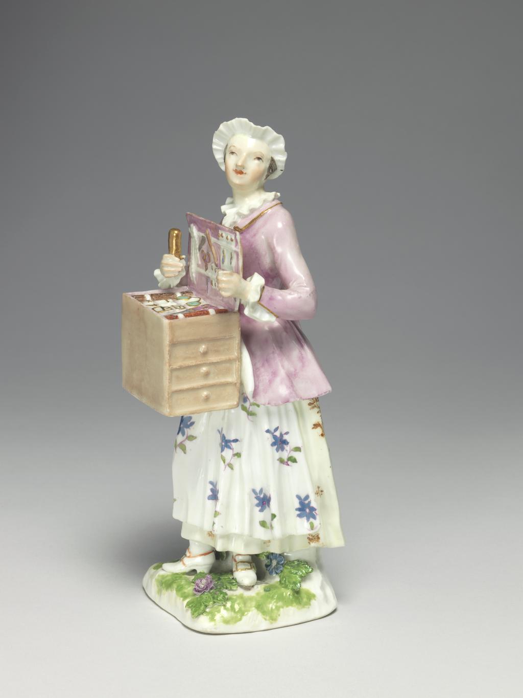 An image of A Trinket Seller. Meissen Porcelain Manufactory, Saxony. Hard-paste porcelain painted in enamels, height, whole, 18.7 cm, width, whole, 6.5 cm, circa 1745-1750.