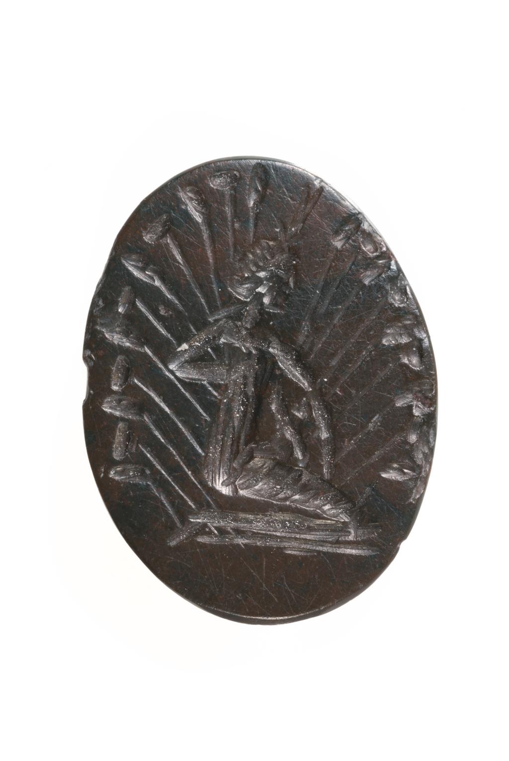 An image of Engraved gems. Magical amulet. Obverse: Isis kneeling in profile to the left, encircled by stalks of papyrus arranged like rays. She holds the infant Horus upon her knees. Her hair is bound in a bun on the nape of her neck, and on her brow is the lotus diadem. Ground line. reverse: blank. Intaglio cutting, bloodstone, 17 mm x 13 mm, circa 100-circa 300. Roman Imperial.