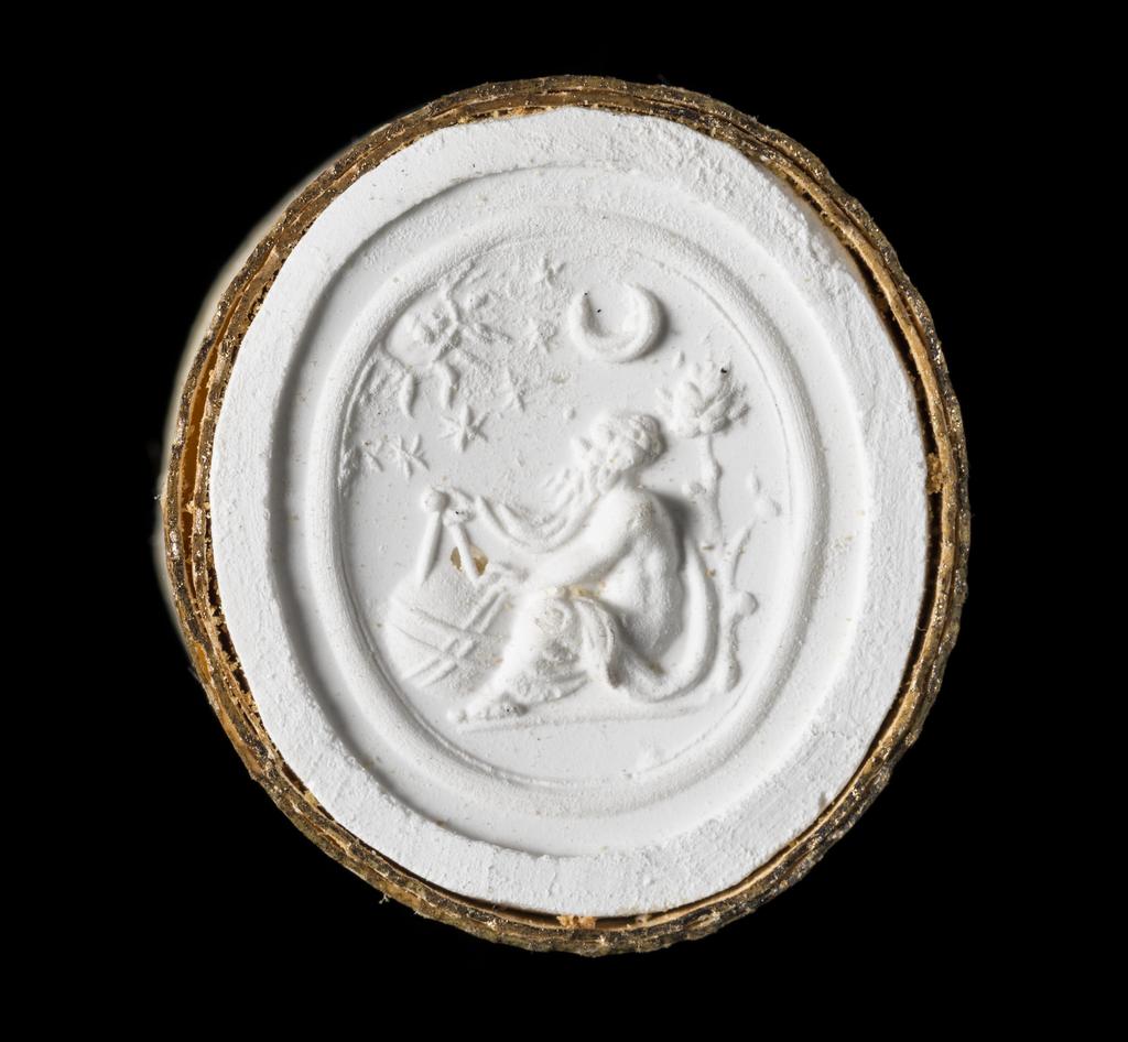 An image of Engraved gems/ringstone/intaglio. An astronomer wearing a himation, left arm and shoulder bare, sitting on the ground beneath a tree, in profile to the left. He is measuring a globe with compasses held in his right hand; the sun, the moon and five stars above him, formerly picked out with pyretic inclusions. Mount: gold ring, type 1a. Intaglio cutting. Lapis lazuli, 12.5 mm, 10.5 mm, circa 1500-1600.