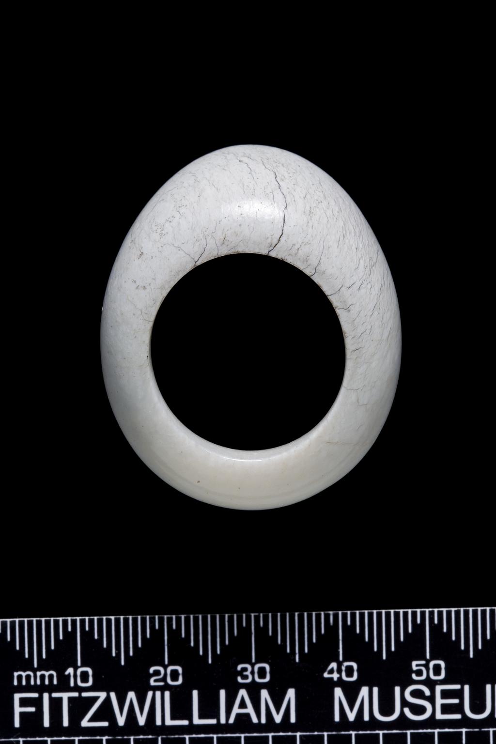An image of Thumb ring. Opaque white jade with plain surface. Nephrite, length 4.2 cm, 1800-1900, Chinese.