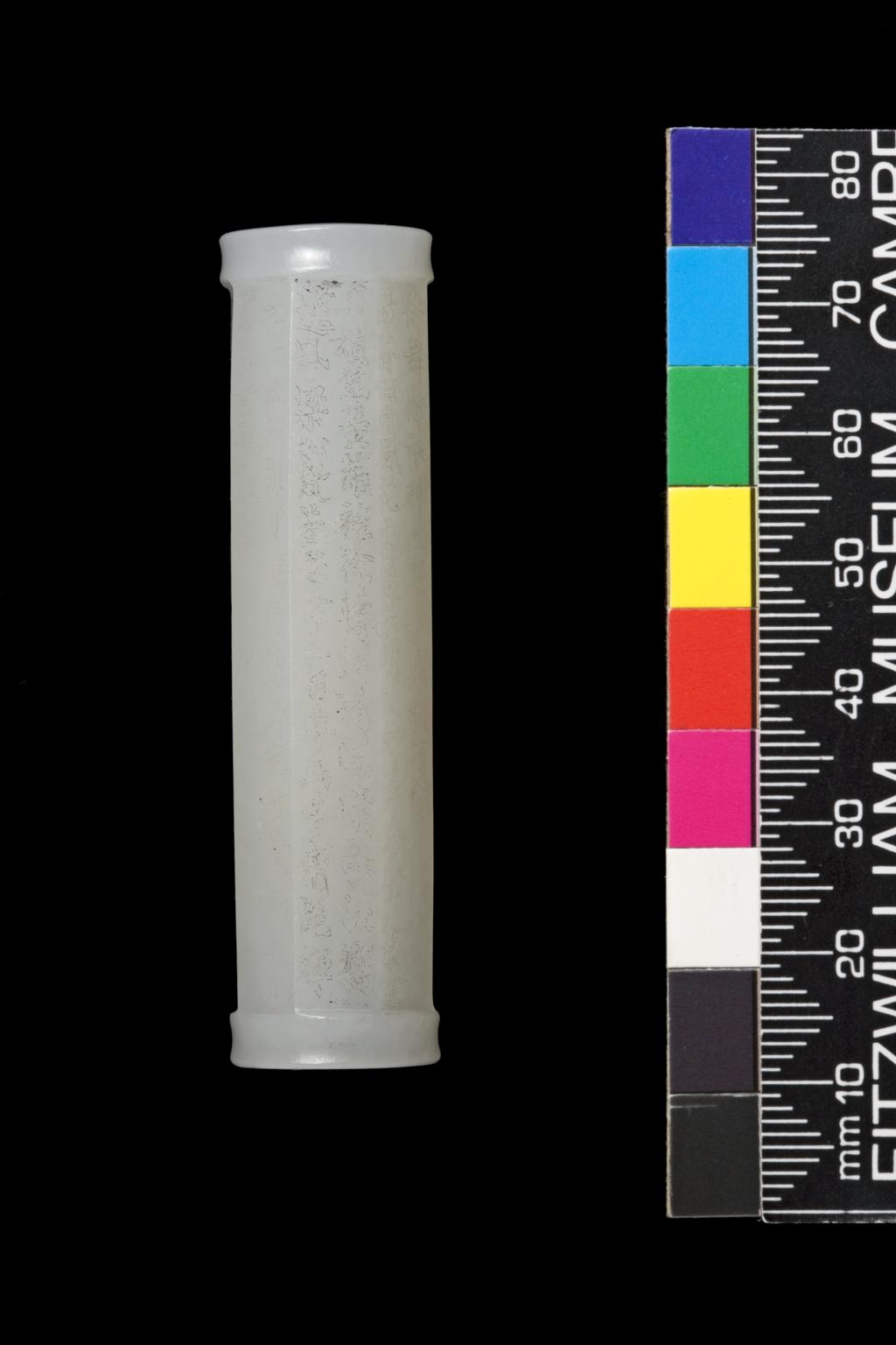 An image of Bead, tubular shape. White jade, eight sided tubular bead with very fine inscriptions on each side of the Cong, tube. Nephrite, height 6.2 cm, diameter 1.6 cm, 1850-1900. Chinese.