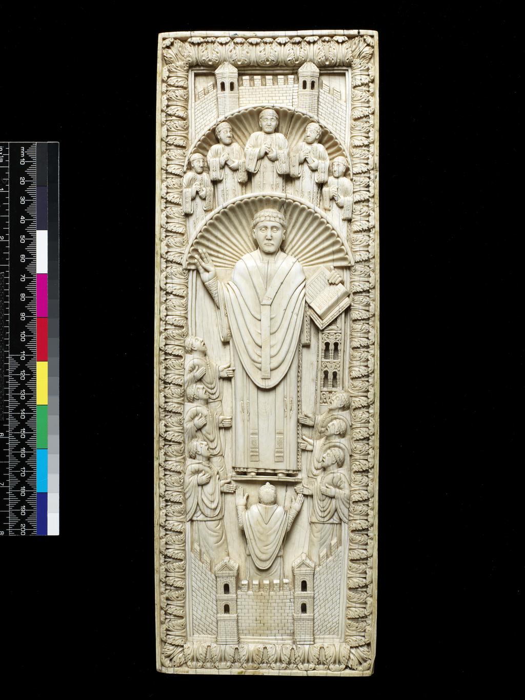 An image of Sculpture. An Archbishop among his Choir. Ivory, carved, height (whole) 33.7 cm, width (whole) 11.4 cm, depth (whole) 1.2 cm, circa 950 to 1000. Unknown, maker, probably, Lotharingia.