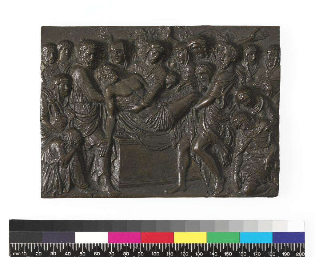 An image of Sculpture/Plaque. The Entombment. Riccio, Andrea (Andrea Briosco), (Italian, 1470-1532). The body of the dead Christ is lowered into the tomb by St John and two bearded men. To the right is the Virgin attended by three women; to the left is a seated mourner and an old woman holding an ewer. In the background are mourners who raise their arms in lamentation. Bronze, cast, with dark brown patina, height, whole, 11.8 cm, width, whole, 16.6 cm, circa 1520. Renaissance.