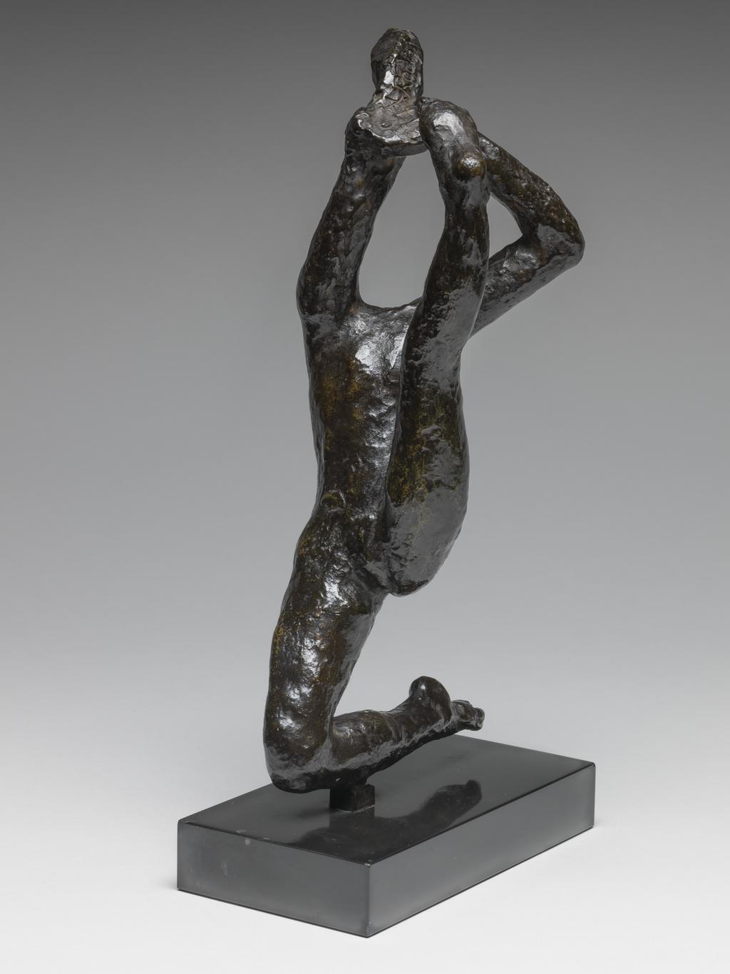 An image of Sculpture/Figure. Movement de Danse H. Rodin, Auguste (French, 1840-1917). Rudier, Georges, founder, Paris, Colmar. Bronze, cast, with rough surface, and very dark brown, shiny patination, attached by a rectangular tenon to a rectangular, straight-sided black marble base. The dancer is headless. She kneels on her right leg, leaning backwards, with her left leg stretched out upwards in front of her. Her arms are extended upwards, and in her right hand he holds an indeterminate object. Bronze, cast, with dark brown patina; on black marble base. Height, bronze, 26 cm, height, whole, 29.4 cm, height, base, 2.5 cm, length, base, 15 cm, width, base, 8 cm, circa 1950-1965. Conceived c. 1911, cast probably 1950s when Roland Browse & Delbanco included several of the dancers in their exhibitions, or between 1963-65.