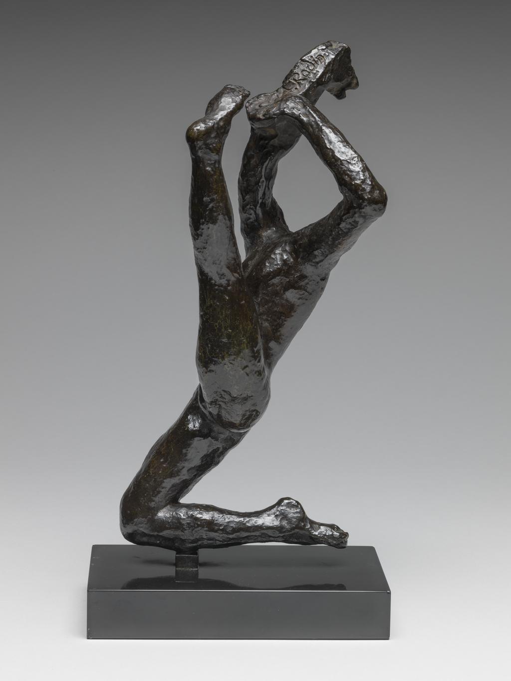 An image of Sculpture/Figure. Movement de Danse H. Rodin, Auguste (French, 1840-1917). Rudier, Georges, founder, Paris, Colmar. Bronze, cast, with rough surface, and very dark brown, shiny patination, attached by a rectangular tenon to a rectangular, straight-sided black marble base. The dancer is headless. She kneels on her right leg, leaning backwards, with her left leg stretched out upwards in front of her. Her arms are extended upwards, and in her right hand he holds an indeterminate object. Bronze, cast, with dark brown patina; on black marble base. Height, bronze, 26 cm, height, whole, 29.4 cm, height, base, 2.5 cm, length, base, 15 cm, width, base, 8 cm, circa 1950-1965. Conceived c. 1911, cast probably 1950s when Roland Browse & Delbanco included several of the dancers in their exhibitions, or between 1963-65.