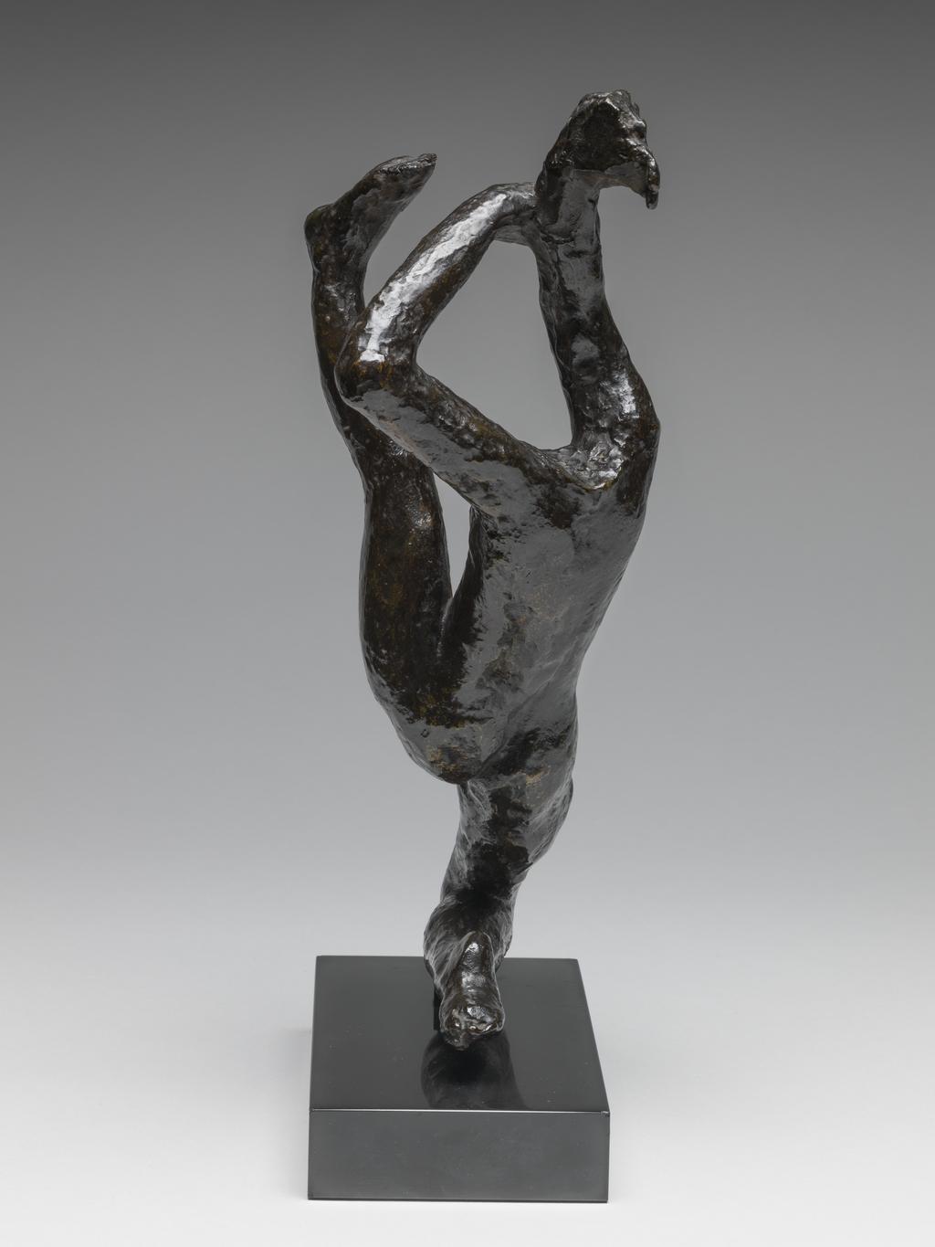 An image of Sculpture/Figure. Movement de Danse H. Rodin, Auguste (French, 1840-1917). Rudier, Georges, founder, Paris, Colmar. Bronze, cast, with rough surface, and very dark brown, shiny patination, attached by a rectangular tenon to a rectangular, straight-sided black marble base. The dancer is headless. She kneels on her right leg, leaning backwards, with her left leg stretched out upwards in front of her. Her arms are extended upwards, and in her right hand he holds an indeterminate object. Bronze, cast, with dark brown patina; on black marble base. Height, bronze, 26 cm, height, whole, 29.4 cm, height, base, 2.5 cm, length, base, 15 cm, width, base, 8 cm, circa 1950-1965. Conceived c. 1911, cast probably 1950s when Roland Browse & Delbanco included several of the dancers in their exhibitions, or between 1963-65.