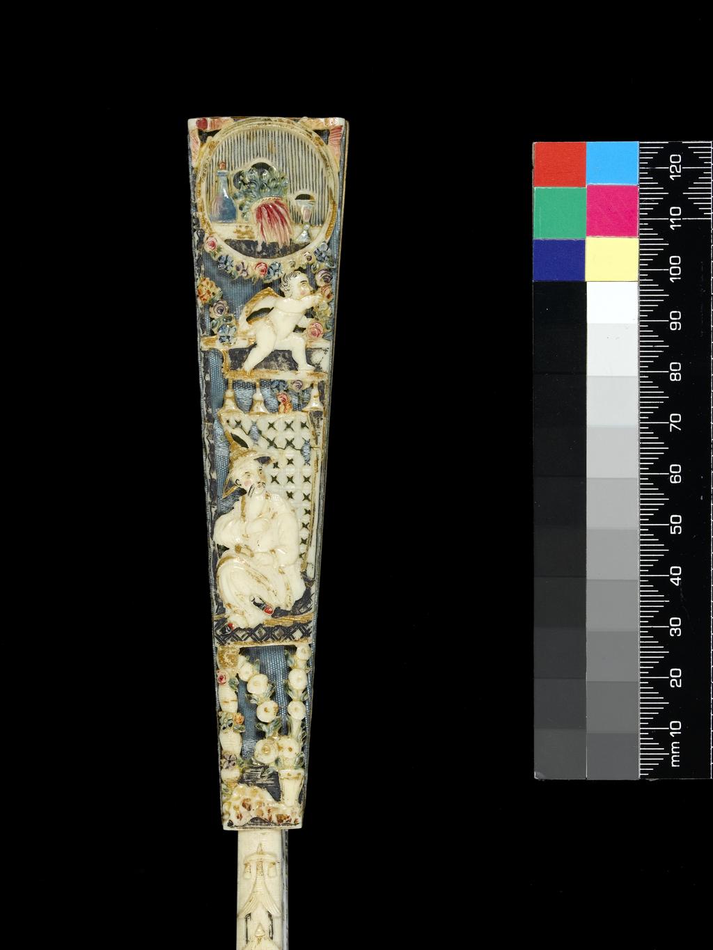 An image of Folding Fan. Double leaf of paper, painted in bodycolour and gilt. Sticks and guards of pierced, fretted, carved, painted and gilt ivory (10+2), the piercing of the guards backed with blue silk, and the head strengthened with tortoiseshell. Rivet set with clear pastes. Length (guards) 28.8 cm, width (leaf) 52 cm. Circa 1750-1760. Italian.