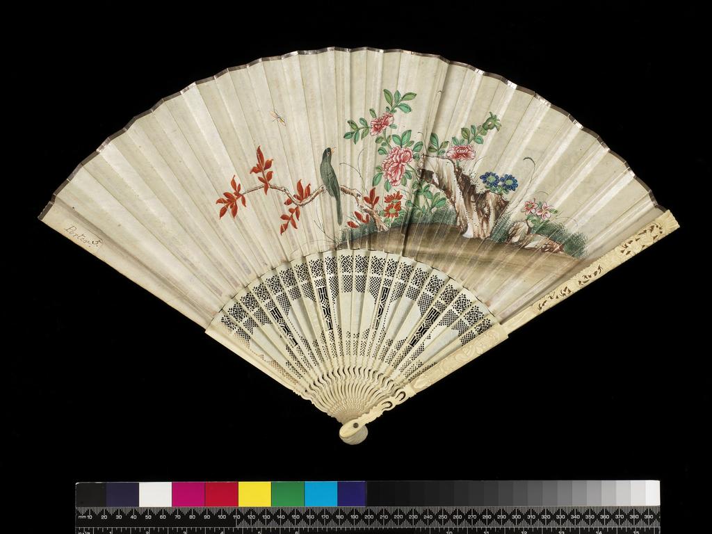 An image of Folding fan of double paper, painted in colours with a Chinese genre scene in a landscape. Sticks and guards of pierced ivory. Length, guard, 26.9 cm, 1770-1790. Chinese, possibly. Messel-Rosse Collection.