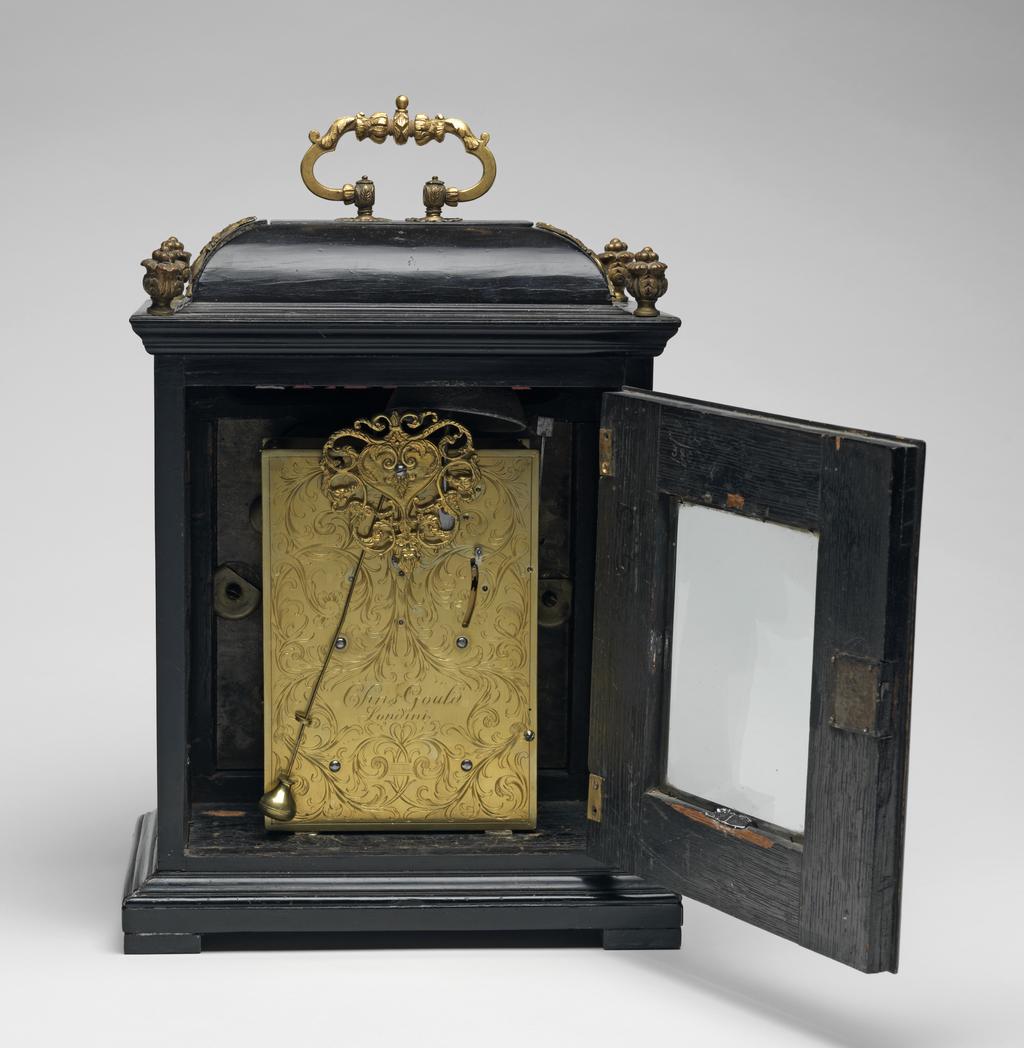 An image of Table Clock. Gould, Christopher, maker of movement (British, London). An 8-day ebony table clock with back plate inscribed 'CHRISTOPHER GOULD LONDON'. Height, case, 37 cm, circa 1695. Production Note: Reconverted early twentieth century to verge with later back-cock.