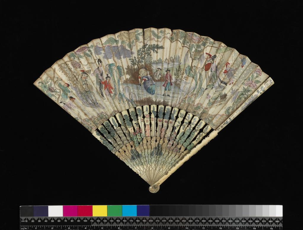 An image of Folding fan with a central pastoral scene of a seated European courting couple, watched by two men, set against a European-style landscape, the whole flanked by oriental motifs and figures within oriental landscapes. Paper leaf decorated on one side with hand-coloured etching, the top edge reinforced with an adhered narrow plain paper border, on shaped, painted, and varnished elephant ivory sticks and guards. Circa 1740. Chinoiserie. English.