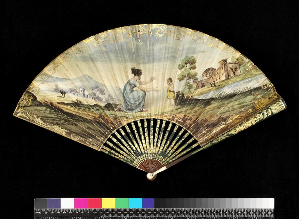 An image of Folding Fan. English, unknown maker. Front: In the middle a young mother kneels in profile, holding out her arms to a small boy standing in front of her. Landscape background with distant hills, a lake or river and buildings. Gilt scroll border on the left, upper and right sides. Reverse: A floral spray in red, pink, green and gold. Sticks and guards: Oriental style plants, a pavillion by a tree and criss-cross diaper. The green lacquer and design stops short of the head. Reverse plain wood. Double paper leaf stipple printed, painted in water-colours and gilt. Gold paper binding on the upper edge. Sticks and guards of wood, lacquered green and gilt, the head of the latter strengthened with ivory (18+2). Rivet with mother-of-pearl washers. Length, guards, 25.6 cm, 1809. Notes: The source of the design was an engraving by M.N. Bate after Adam Buck (1759-1833) entitled 'Step by Step' in the series 'The Progress of Human Life'. It was printed by Ackerman, 101, Strand, London.