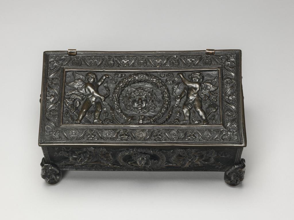 An image of Metalwork. Writing casket. Bronze, cast, height, whole, 10.2 cm, circa 1475-1525. The lid is associated, and the feet were added in the 19th century. Production Note: When purchased in 1937 the casket was attributed to Caradosso. Renaissance.