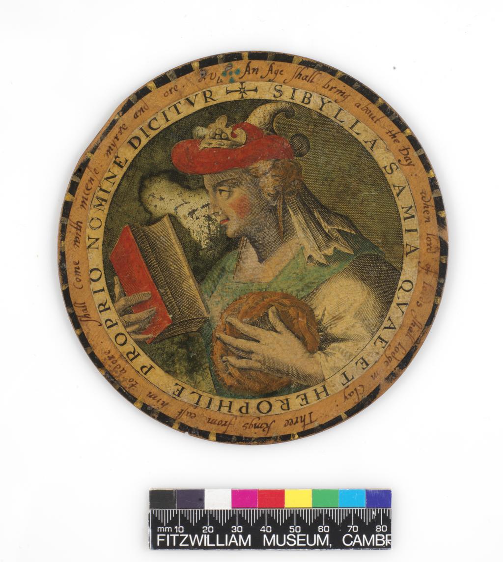 An image of Roundel or trencher. One of twelve wooden roundels, with an applied print of the Samian Sibyl. Hand-coloured in red, green, ochre and black. Inscribed in black ink. Undecorated reverse. With a small hole near the top at the edge, diameter, 13.7, cm circa 1601-1625. Part of M.5.1-13 & A-1920: Box containing twelve roundels or trenchers. Unknown maker, after Passe, Crispijn I de, printmaker (Flemish, 1564-1637). Circular box and cover of turned wood, containing twelve roundels. Each decorated with an applied hand-coloured engraving of a Sibyl, surrounded by a hand-written English inscription. Height, box, 6.7 cm, diameter, box, 17.1 cm, diameter, roundels, 13.7 cm, circa 1601 to circa 1625.