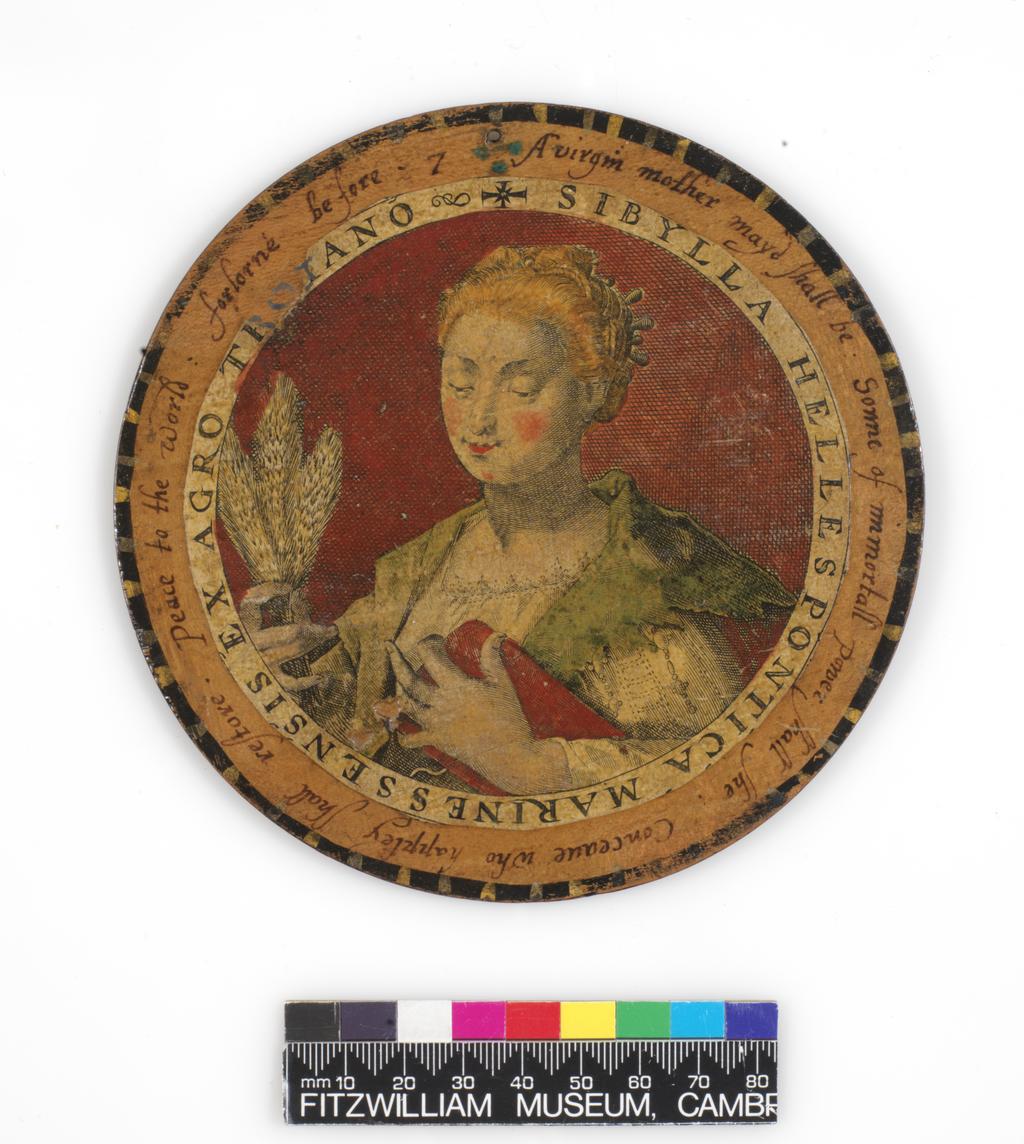 An image of Roundel or trencher. One of twelve wooden roundels, with an applied print of the Hellespontine Sibyl. Hand-coloured in red, green, ochre and black. Inscribed in black ink. Undecorated reverse. With a small hole near the top at the edge, diameter, 13.7, cm, circa 1601-1625. Part of M.5.1-13 & A-1920: Box containing twelve roundels or trenchers. Unknown maker, after Passe, Crispijn I de, printmaker (Flemish, 1564-1637). Circular box and cover of turned wood, containing twelve roundels. Each decorated with an applied hand-coloured engraving of a Sibyl, surrounded by a hand-written English inscription. Height, box, 6.7 cm, diameter, box, 17.1 cm, diameter, roundels, 13.7 cm, circa 1601 to circa 1625.