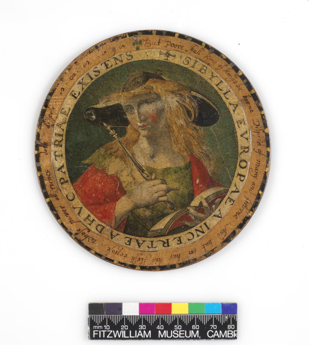 An image of Roundel or trencher. One of twelve wooden roundels, with an applied print of the Egyptian Sibyl. Hand-coloured in red, green, ochre and black. Inscribed in black ink. Undecorated reverse. With a small hole near the top at the edge, diameter 13.7 cm. Part of M.5.1-13 & A-1920: Box containing twelve roundels or trenchers. Unknown maker, after Passe, Crispijn I de, printmaker (Flemish, 1564-1637). Circular box and cover of turned wood, containing twelve roundels. Each decorated with an applied hand-coloured engraving of a Sibyl, surrounded by a hand-written English inscription. Height, box, 6.7 cm, diameter, box, 17.1 cm, diameter, roundels, 13.7 cm, circa 1601 to circa 1625.