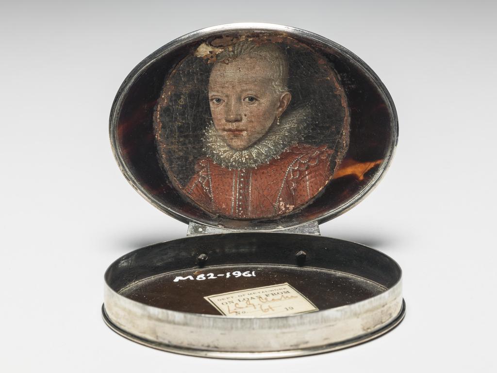 An image of Miniature painting. Snuff box/Objets de vertu. Unknown Boy in a Ruff, Aged 3 years. Unknown Italian miniaturist. Unknown French silversmith. Oval, silver box with tortoise shell lid and base, the lid inlaid with silver piqué work with a man stretching into a palm tree beside which is a scroll inscribed 'CRESCIT SUB PONDERE'. Glued inside the lid is a circular miniature of an unknown boy in a red jacket and white ruff, inscribed in gold "AEta.3.1615". The tortoiseshell was carved from a turtle shell, which was heated and pressed to form the lid and base. Height, miniature, 52 mm, width, miniature, 54 mm; length, whole box, 8.1 cm, width, whole box, 6.2 cm, height, whole box, 1.6 cm, circa 1600. The box does not bear any hallmarks. Notes: The box was probably made in France circa 1710, and the miniature was probably painted in Italy one hundred years earlier.