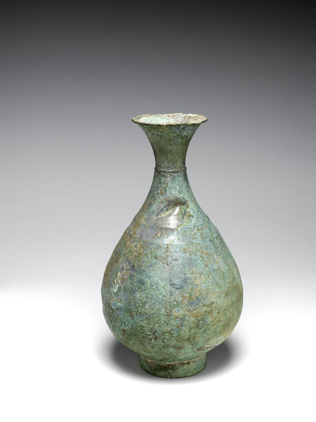 An image of Vessel. A pear-shaped vase with elegant flaring mouth, a slight ridge-collar at narrowest part on cylinder. Foot rim of bronze, green patinated over silvery surface. Circa 935-1392. Korean.
