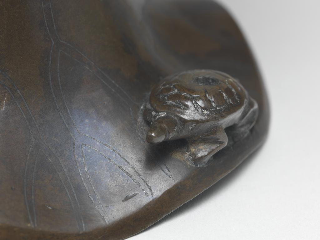 An image of Bronze candlestick, inlaid with silver, in the shape of a lotus leaf with a wavy edge. possibly Korean. 1600-1799.