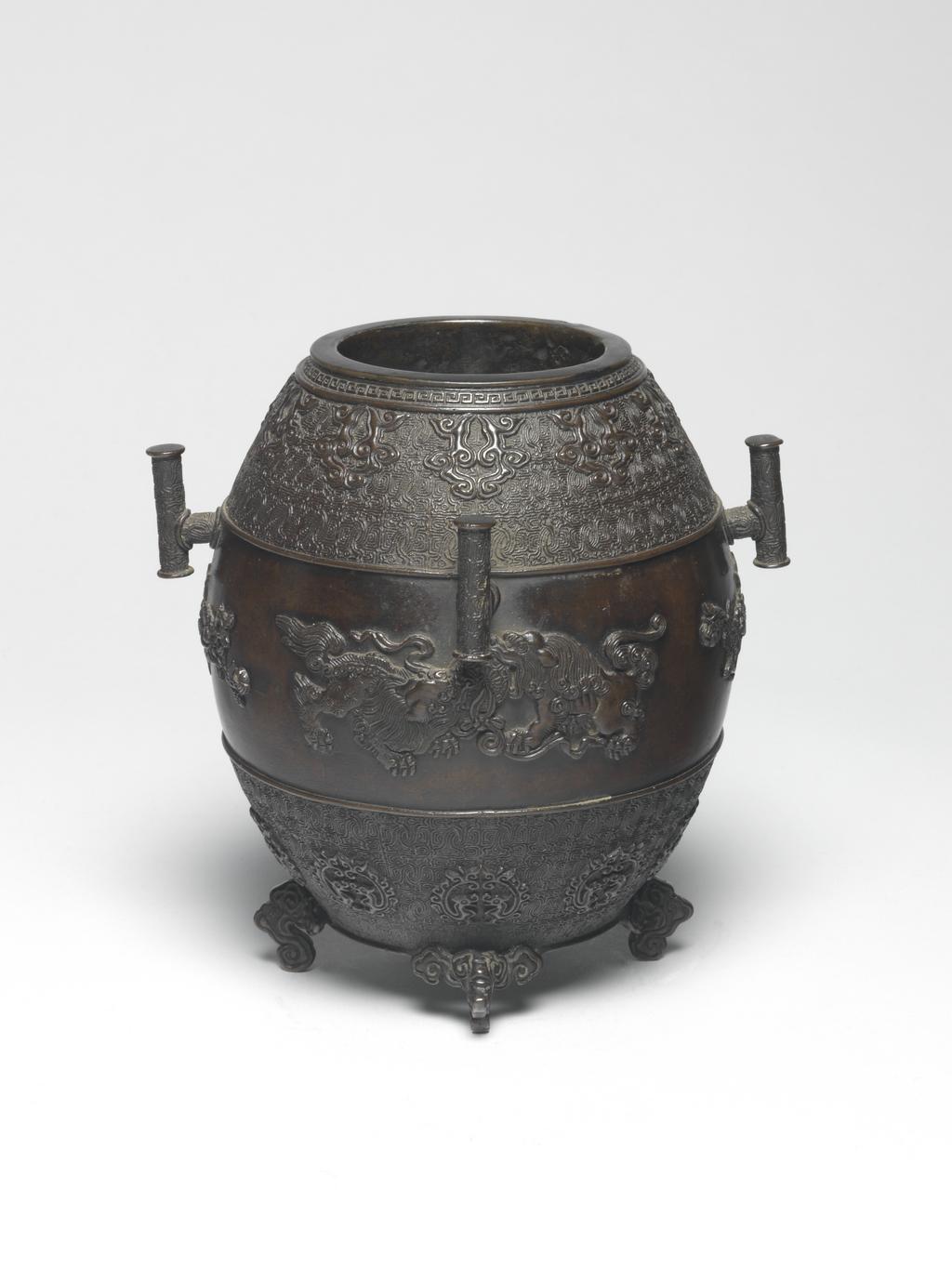 An image of Bronze censer. Seimin, Muraka (Japanese). Moulded, case decorated with two pairs of lions confronting each other on the surface. The censer is inscribed underneath with nine characters. Circa 1818-1829.