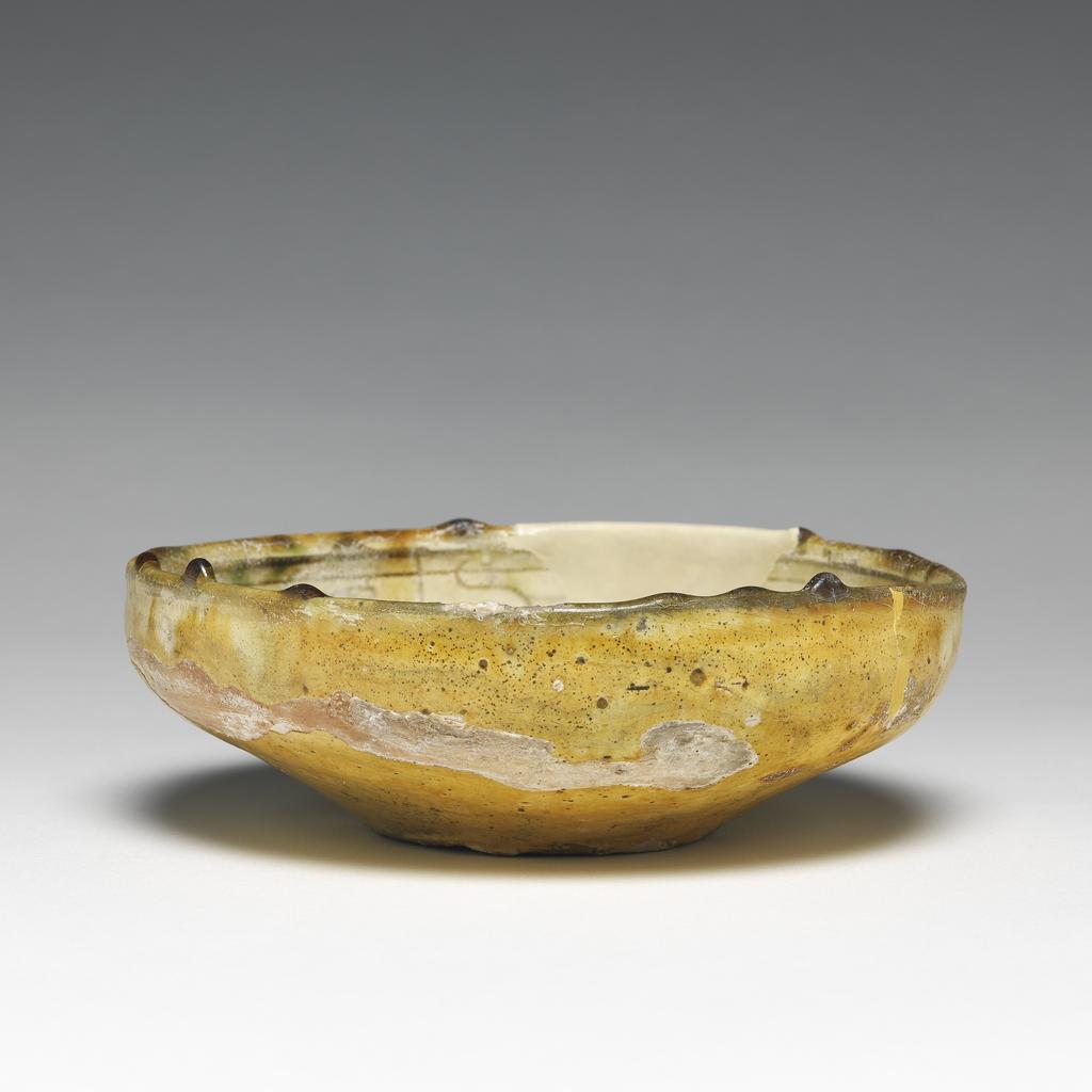 An image of Bowl. Unknown maker, Cyprus. Earthenware, coated with white slip. With decoration scratched through it under a polychrome coloured glaze, 1400-1599.