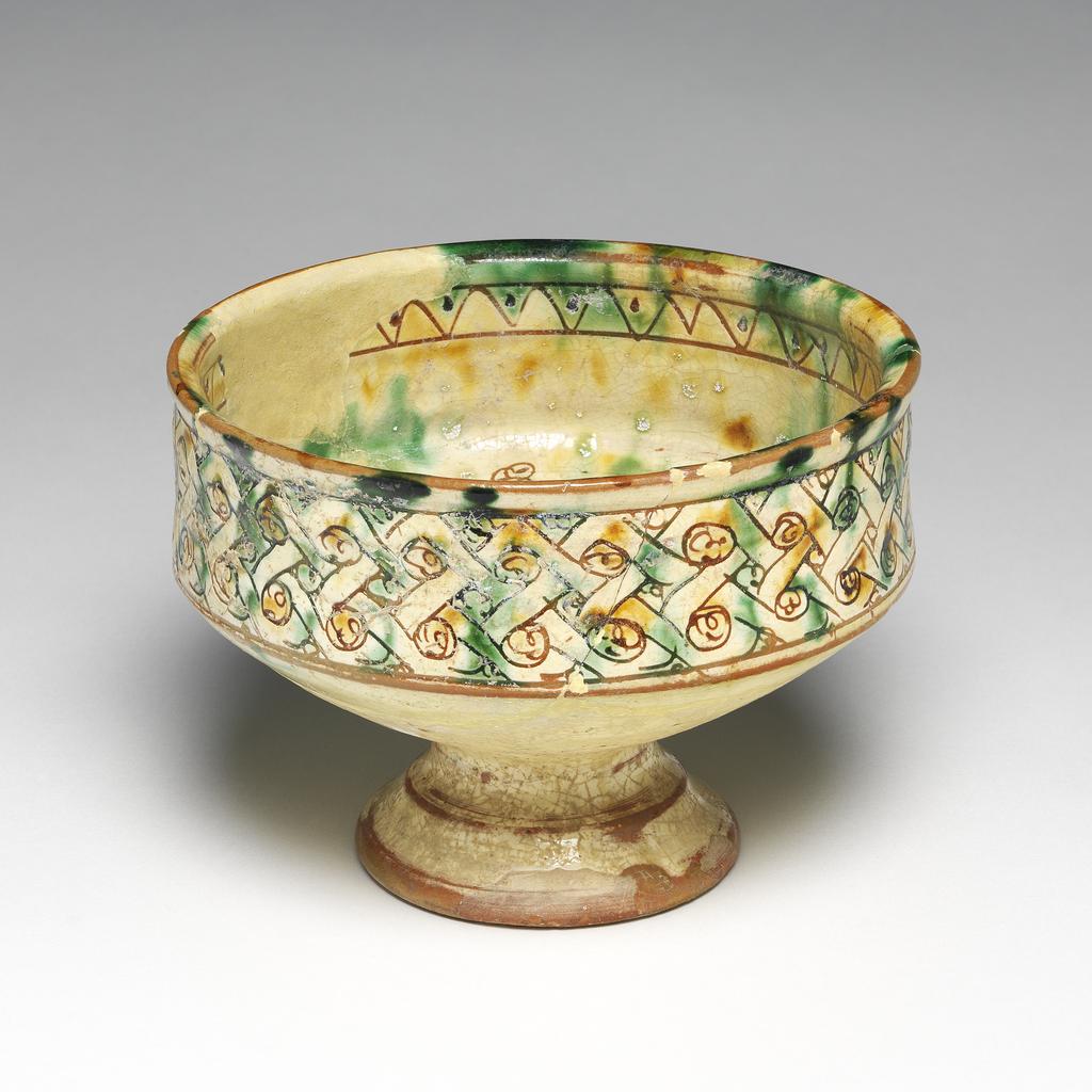 An image of Bowl. Unknown maker, Cyprus. Decorated with a grotesque animal or bird. Earthenware, height 8.5, cm, width 14 cm, 1300-1499.
