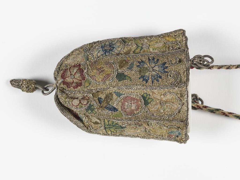 An image of Textiles/embroidery/purse. Worked with polychrome silks, gilt and silver threads in couching, buttonhole and plaited braid stitches with woven bosses; 8 vertical compartments, each containing a long spray with circular stems bearing various flowers (cornflower, rose, strawberry). Gathered at the bottom, drawstring missing, handle of plaited silk attached by Turks head knots of silver cord lined with green silk. Height, whole, 3.25 in, width, whole, 2.75 in, after 1601 to before 1700. English.