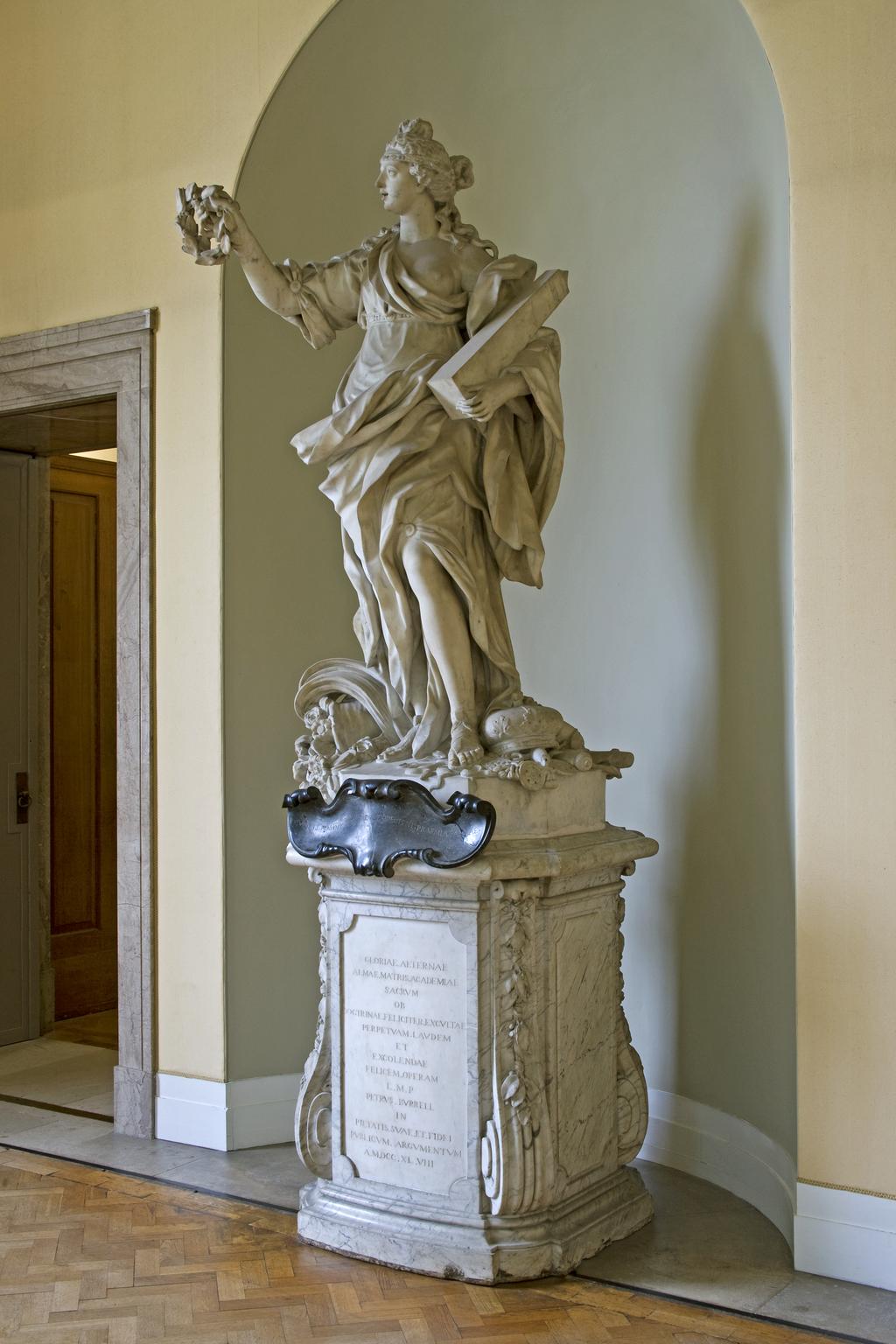 An image of BARATTA, Giovanni (the Younger)GloryCarrara white marble, carved in the round; on grey veined marble pedestal, with black marble cartouche. A full length figure of a woman, representing 'Glory' supported on a high pedestal.The inscription on the black marble is not the original as devised by James Brydges, first Duke of Chandos (1784-1744) which read: GLORIA MARLBURI, LAURO TUA TEMPORA CINGIT/DIVA LUBENS QUORSIUM? PAR DECUS INDE REFERT.C.1715Florence, Italy