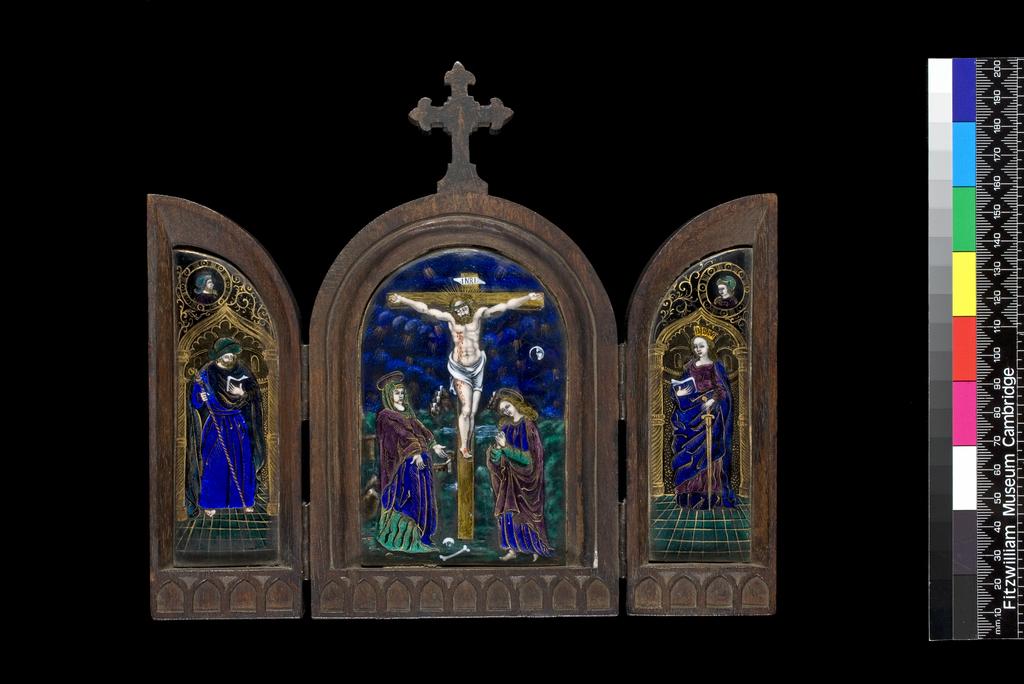 An image of Limoges Painted Enamel
Crucifixion with St James and St Catherine
Copper, decorated in translucent and opaque enamels, partly over foils. The Crucifixion in the centre panel with St James on the left wing and St Catherine on the right wing.
Three copper plaques, almost flat, and partly foiled in silver, enamelled in translucent royal blue, two shades of green, and mulberry, and opaque flesh, red, white, and black,and gilded.       The central arched plaque is decorated with the Crucifixion. Christ hangs on a gold tau cross with the word INRI on a label above his head. He wears a crown of thorns and a loin cloth and blood streams from a wound in his right side. The Virgin Mary stands on the left with her hands extended, wearing a green veil,  a royal blue gown over a green skirt, and a mulberry cloak. St John stands on the right with his hands clasped in prayer, wearing a blue gown with green sleeves, and a mulberry cloak. The blue background is scattered with small groups of gold rays of light, and on the right is a white crescent moon enclosing a profile face. The left panel is decorated with St James standing within an archway on a green tiled floor. He holds a staff in his right hand and an open book in his left, and wears a green hat, blue gown, and a blue-black cloak. Above the arch is a circular medallion of a bearded man in profile to right wearing a green helmet. The right panel is decorated with St Catherine stands on a green tiled floor  in an archway, holding the hilt of a sword in her right hand, and an open book in her left. She wears a gold crown, a mulberry gown and a royal blue cloak. Above the arch is a circular medallion of a clean-shaven man three-quarters to left. The outlines of the costume, the architecture, and medallions are gilded, and their are gold foliated scrolls in the spaces around the medallions. The panels are enclosed in a hinged wooden frame with a wooden cross at the centre over Christ. The lower edge of the interior is decorated 