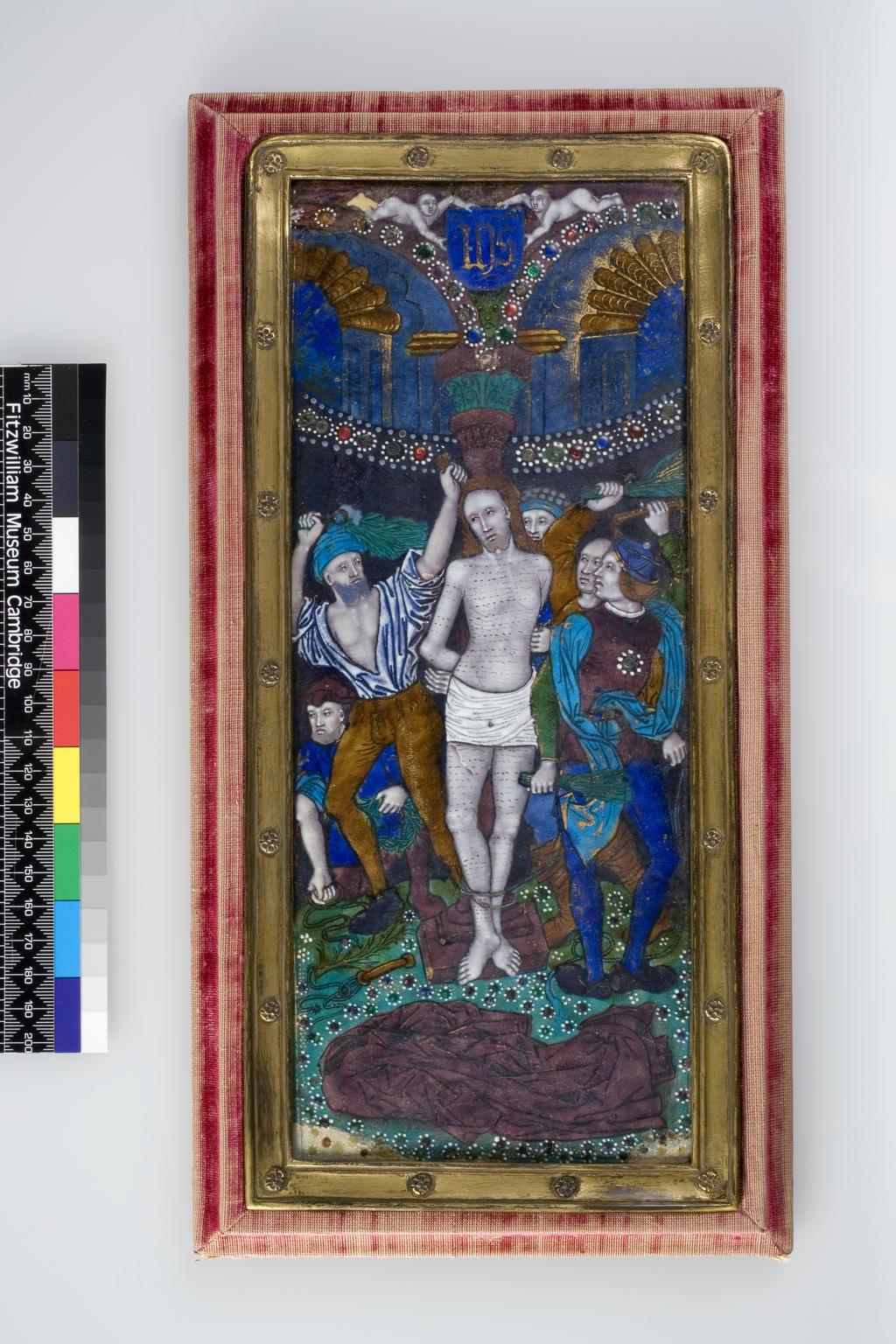 An image of The FlagellationCopper decorated polychrome enamels, jewelling, and gildingRectangular copper plaque with drawing in black over a white ground covered with translucent blue, turquoise, green, tan, and mulberry enamels, opaque red, white, and black enamels, blue, red, and green enamel jewelling over foils, and gilding. The counter enamel is not visible.                                                Christ stands in the centre tied with his arms behind his back to a mulberry column. He is naked except for a white loin cloth and his arms, torso and legs are covered with horizontal lines of drops of blood. His mulberry-coloured cloak lies in the foreground on greensward scattered with numerous flowers with red and green jewelled centres and white dotted petals. Two men on the right and one on the left stand with their arms raised holding bunches of green twigs with which they are about to strike Christ. Another man kneels on the left holding a snaking cord in his right hand and a crown of thorns in his left. The head of another is visible behind the column. Above the figure there is a black drape bordered by a curved line of red, blue and green jewels with white dotted edges. Above it, two flutted arches with jewelled edges spring from the green capital of the column. In the spandrel between them is a green mask, and a blue shield bearing the mnogram IHS in gothic letters, held up by two putti who lie horizontally on the top of the arches. Remnants of lavish gilding are visible on the figures and arches. The narrow gilt-metal inner frame has eighteen flower headed rivets. The outer frame of the stand is covered in very worn crimson velvet and is backed by crimson damask with a hinged prop in the middle.Limoges, FranceC.1520