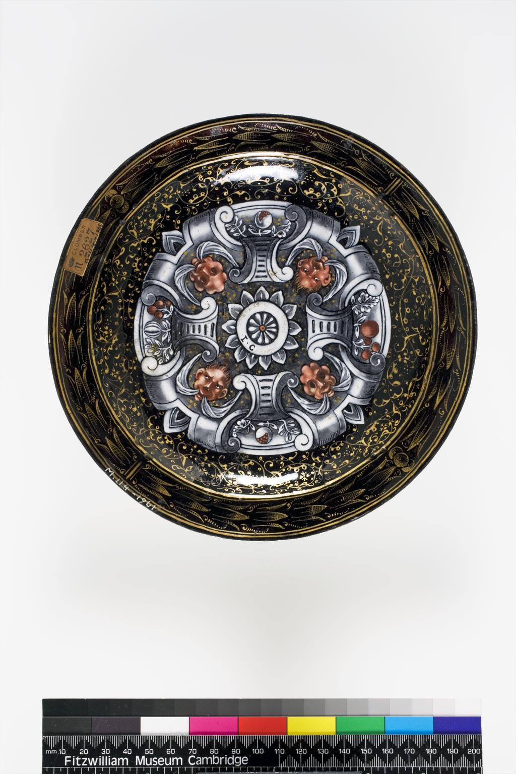 An image of Limoges Enamel Plate. Court dit Vigier, Jean I (French, d. 1592). Court dit Vigier, Jean II (French, c.1575 to beween 1631-1635). The Egyptians adoring Joseph in Pharaoh's Chariot or The Triumph of Joseph. Circular with slightly raised edge, narrow rim, and shallow well with curved sides. Copper, enamelled in polychrome and grisaille, and gilded. Height, whole, 2.2 cm, diameter, whole, 19.9 cm, circa 1564-1610. Limoges, France.