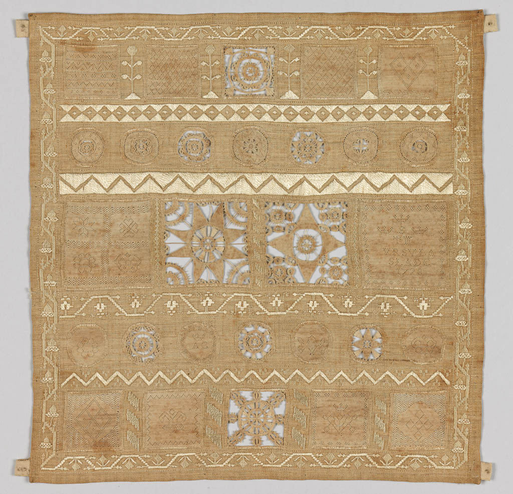 An image of Textiles. Whitework sampler. Slade, Ursula (English). The sampler is almost square in shape and is made up of inserted panels of hollie point and needle lace, neatly divided and bordered by repeat patterns in counted satin stitch. The sampler carries the inscription 'VrsVla/Slade' in the middle right panel. Linen embroidered with linen thread in satin and back stitch with hollie point and needle lace insertions. All the edges are hemmed. Length 21.75 cm, width 21 cm, 1728.