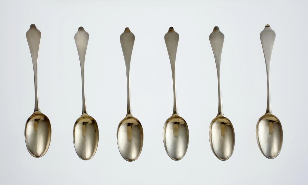 An image of Teaspoon/spoons. A set of six silver-gilt teaspoons and case. Archer, Andrew, silversmith, possibly, London. Each spoon has oval bowl with rat-tail on the back, and a dog-nose terminal with later engraved initials 'EP'. The spoon-shaped case is covered in shagreen and lined with green velvet. Silver gilt (silver whole, gold surface), length, overall, 12 cm, 1704-1705 . Queen Anne Period.