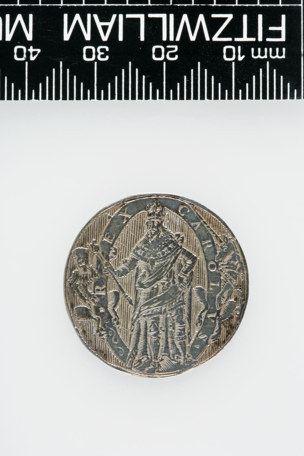 An image of Counter Box containing 32 countersCounter box. Silver, the box pierced, chased, and engraved, containing thirty-two engraved silver counters of English monarchs and their childrenCounter box. Silver, the box pierced, chased, and engraved; the counters engraved. The box is cylindrical with a detachable lid. The base is decorated with a bust of Queen Henrietta Maria in profile to left in low relief in an open oval medallion with pairs of inwards scrolls above and below, and S-scrolls on either side, with a cut away background. The top bears a bust of Charles I in profile to left in an open oval medallion surrounded by four paired scrolls with single scrolls between them, with a cut away background. The sides have two panels each containing pierced scrolling foliage and a monster. The counters are circular, and are engraved with monarchs and coats-of-arms respectively on the two sides: Prince Charles (d. 1130), Edward the Confessor, Willima I (2), William II, John, Edward I, Edward II, Edward III, Edward IV, Edward V, Edward VI, Henry I, Henry II, Henry III, Henry IV, Henry V, Henry VI (2), Henry VII, Henry VIII, Richard I, Richard II, Richard III, Mary I (2), Elizabeth I, Henry father of King James I and VI, James I and VI, Charles I, Elizabeth of Bohemia (his sister), Charles Louis Count of the Palatinate (her son)EnglishC.1640-50