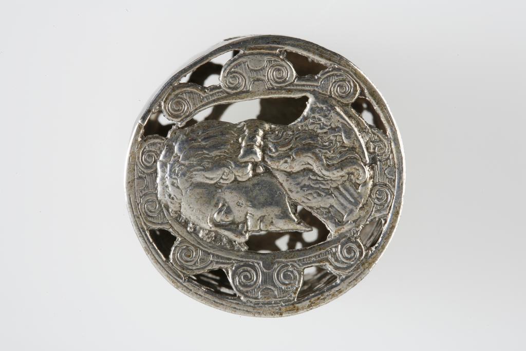 An image of Counter Box containing 32 countersCounter box. Silver, the box pierced, chased, and engraved, containing thirty-two engraved silver counters of English monarchs and their childrenCounter box. Silver, the box pierced, chased, and engraved; the counters engraved. The box is cylindrical with a detachable lid. The base is decorated with a bust of Queen Henrietta Maria in profile to left in low relief in an open oval medallion with pairs of inwards scrolls above and below, and S-scrolls on either side, with a cut away background. The top bears a bust of Charles I in profile to left in an open oval medallion surrounded by four paired scrolls with single scrolls between them, with a cut away background. The sides have two panels each containing pierced scrolling foliage and a monster. The counters are circular, and are engraved with monarchs and coats-of-arms respectively on the two sides: Prince Charles (d. 1130), Edward the Confessor, Willima I (2), William II, John, Edward I, Edward II, Edward III, Edward IV, Edward V, Edward VI, Henry I, Henry II, Henry III, Henry IV, Henry V, Henry VI (2), Henry VII, Henry VIII, Richard I, Richard II, Richard III, Mary I (2), Elizabeth I, Henry father of King James I and VI, James I and VI, Charles I, Elizabeth of Bohemia (his sister), Charles Louis Count of the Palatinate (her son)EnglishC.1640-50