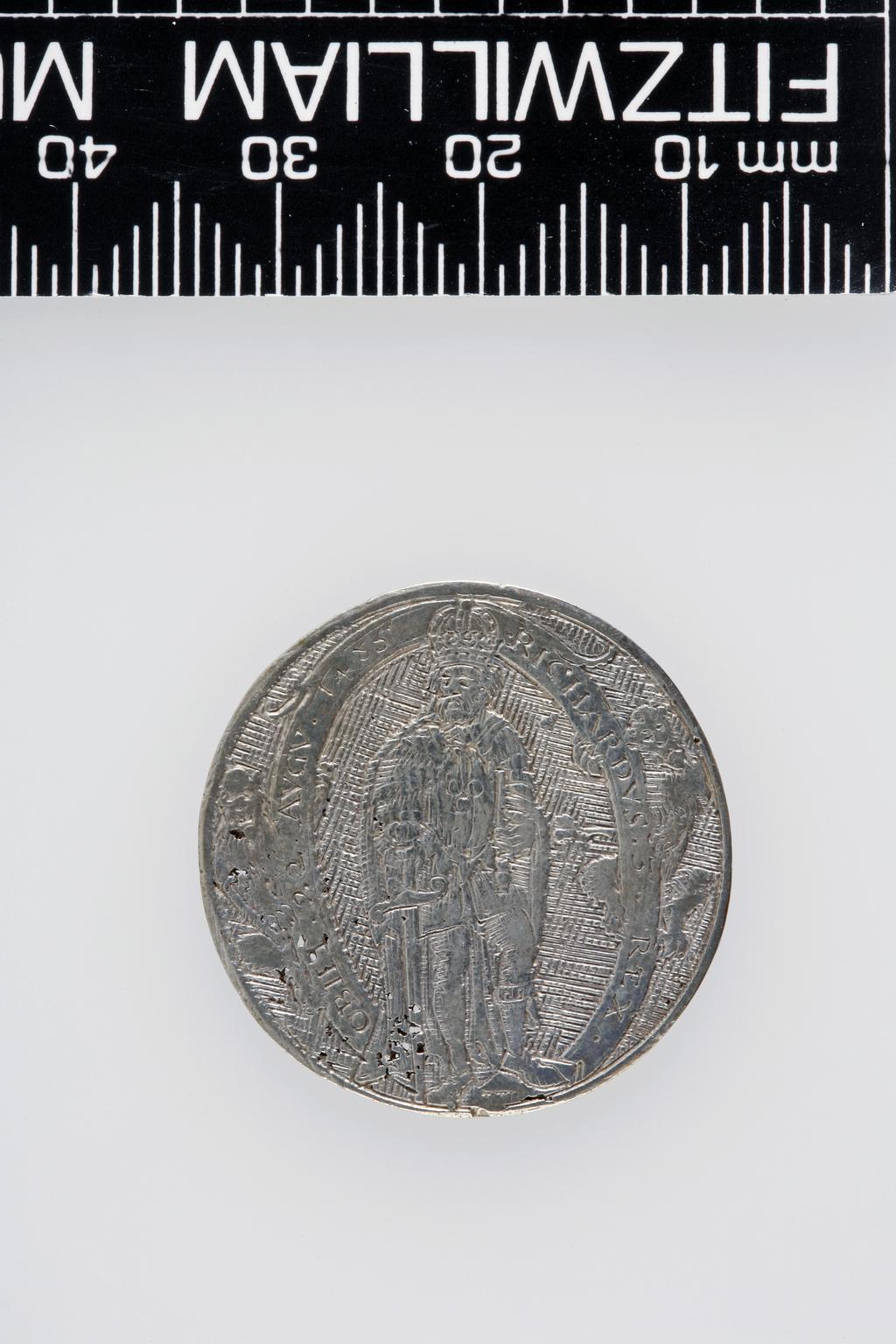 An image of Counter Box containing 32 countersCounter box. Silver, the box pierced, chased, and engraved, containing thirty-two engraved silver counters of English monarchs and their childrenCounter box. Silver, the box pierced, chased, and engraved; the counters engraved. The box is cylindrical with a detachable lid. The base is decorated with a bust of Queen Henrietta Maria in profile to left in low relief in an open oval medallion with pairs of inwards scrolls above and below, and S-scrolls on either side, with a cut away background. The top bears a bust of Charles I in profile to left in an open oval medallion surrounded by four paired scrolls with single scrolls between them, with a cut away background. The sides have two panels each containing pierced scrolling foliage and a monster. The counters are circular, and are engraved with monarchs and coats-of-arms respectively on the two sides: Prince Charles (d. 1130), Edward the Confessor, Willima I (2), William II, John, Edward I, Edward II, Edward III, Edward IV, Edward V, Edward VI, Henry I, Henry II, Henry III, Henry IV, Henry V, Henry VI (2), Henry VII, Henry VIII, Richard I, Richard II, Richard III, Mary I (2), Elizabeth I, Henry father of King James I and VI, James I and VI, Charles I, Elizabeth of Bohemia (his sister), Charles Louis Count of the Palatinate (her son)EnglishC.1640-50