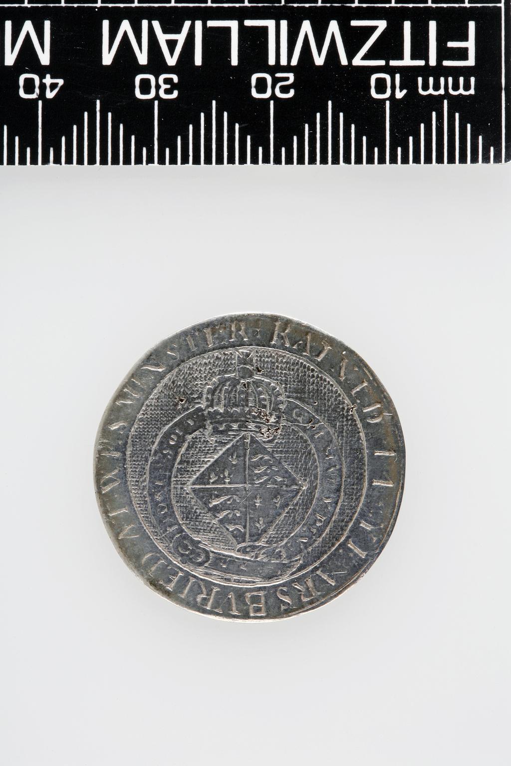 An image of Counter Box containing 32 countersCounter box. Silver, the box pierced, chased, and engraved, containing thirty-two engraved silver counters of English monarchs and their childrenCounter box. Silver, the box pierced, chased, and engraved; the counters engraved. The box is cylindrical with a detachable lid. The base is decorated with a bust of Queen Henrietta Maria in profile to left in low relief in an open oval medallion with pairs of inwards scrolls above and below, and S-scrolls on either side, with a cut away background. The top bears a bust of Charles I in profile to left in an open oval medallion surrounded by four paired scrolls with single scrolls between them, with a cut away background. The sides have two panels each containing pierced scrolling foliage and a monster. The counters are circular, and are engraved with monarchs and coats-of-arms respectively on the two sides: Prince Charles (d. 1130), Edward the Confessor, Willima I (2), William II, John, Edward I, Edward II, Edward III, Edward IV, Edward V, Edward VI, Henry I, Henry II, Henry III, Henry IV, Henry V, Henry VI (2), Henry VII, Henry VIII, Richard I, Richard II, Richard III, Mary I (2), Elizabeth I, Henry father of King James I and VI, James I and VI, Charles I, Elizabeth of Bohemia (his sister), Charles Louis Count of the Palatinate (her son)EnglishC.1640-50