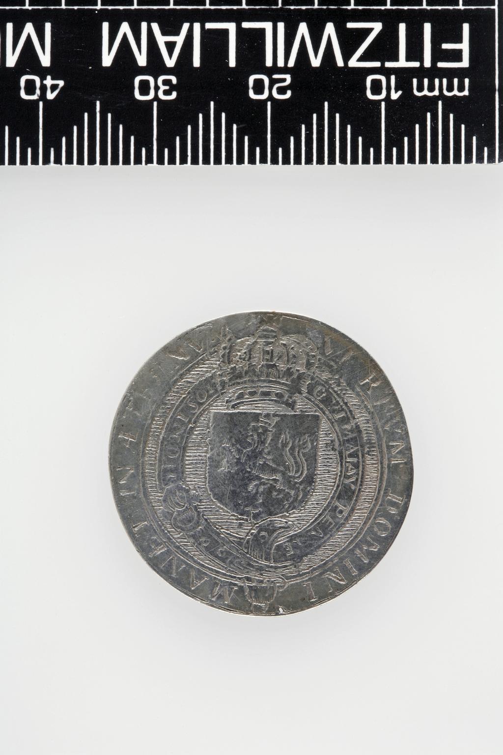 An image of Counter Box containing 32 countersCounter box. Silver, the box pierced, chased, and engraved, containing thirty-two engraved silver counters of English monarchs and their childrenCounter box. Silver, the box pierced, chased, and engraved; the counters engraved. The box is cylindrical with a detachable lid. The base is decorated with a bust of Queen Henrietta Maria in profile to left in low relief in an open oval medallion with pairs of inwards scrolls above and below, and S-scrolls on either side, with a cut away background. The top bears a bust of Charles I in profile to left in an open oval medallion surrounded by four paired scrolls with single scrolls between them, with a cut away background. The sides have two panels each containing pierced scrolling foliage and a monster. The counters are circular, and are engraved with monarchs and coats-of-arms respectively on the two sides: Prince Charles (d. 1130), Edward the Confessor, Willima I (2), William II, John, Edward I, Edward II, Edward III, Edward IV, Edward V, Edward VI, Henry I, Henry II, Henry III, Henry IV, Henry V, Henry VI (2), Henry VII, Henry VIII, Richard I, Richard II, Richard III, Mary I (2), Elizabeth I, Henry father of King James I and VI, James I and VI, Charles I, Elizabeth of Bohemia (his sister), Charles Louis Count of the Palatinate (her son)EnglishC.1640-50