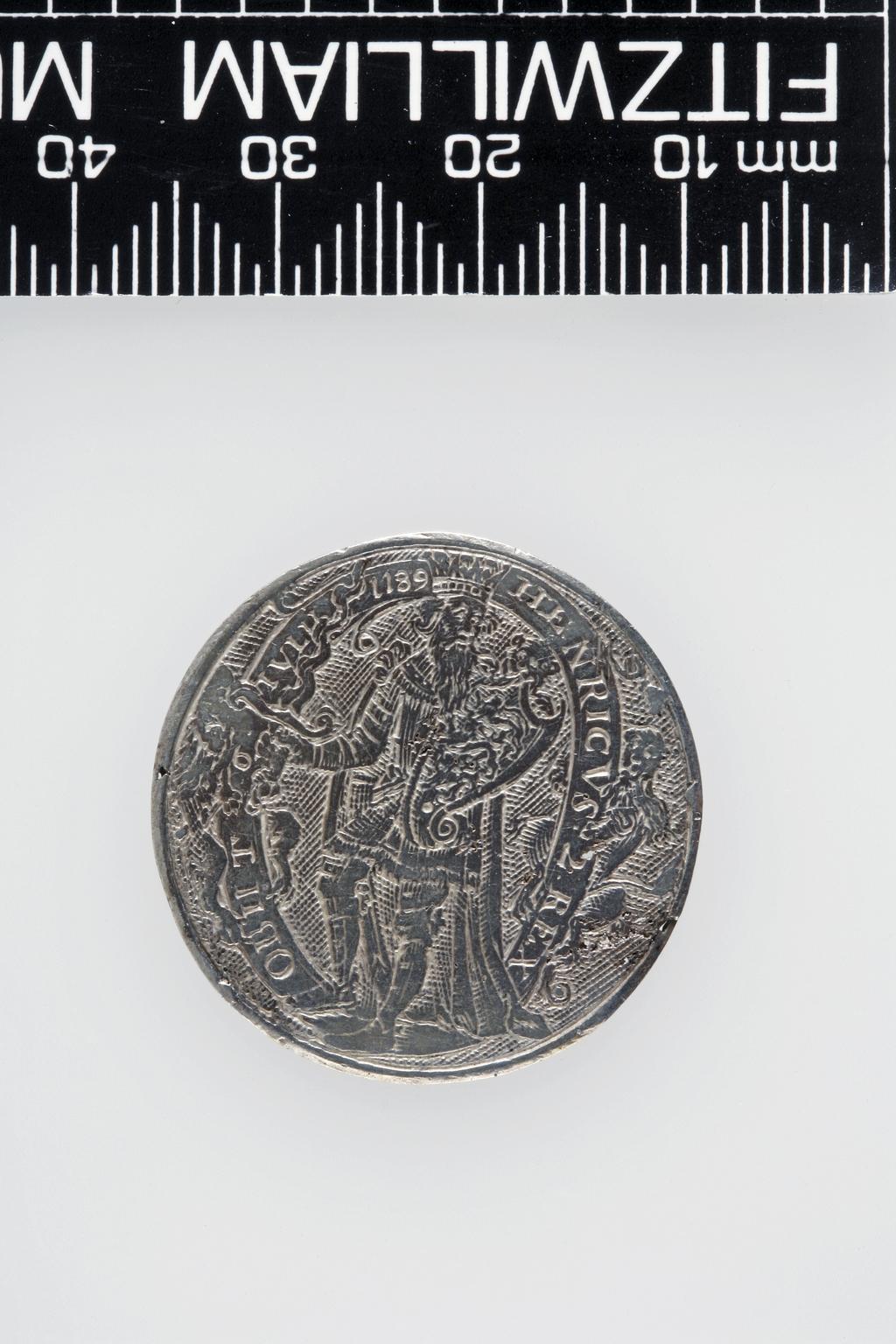 An image of Counter Box containing 32 countersCounter box. Silver, the box pierced, chased, and engraved, containing thirty-two engraved silver counters of English monarchs and their childrenCounter box. Silver, the box pierced, chased, and engraved; the counters engraved. The box is cylindrical with a detachable lid. The base is decorated with a bust of Queen Henrietta Maria in profile to left in low relief in an open oval medallion with pairs of inwards scrolls above and below, and S-scrolls on either side, with a cut away background. The top bears a bust of Charles I in profile to left in an open oval medallion surrounded by four paired scrolls with single scrolls between them, with a cut away background. The sides have two panels each containing pierced scrolling foliage and a monster. The counters are circular, and are engraved with monarchs and coats-of-arms respectively on the two sides: Prince Charles (d. 1130), Edward the Confessor, Willima I (2), William II, John, Edward I, Edward II, Edward III, Edward IV, Edward V, Edward VI, Henry I, Henry II, Henry III, Henry IV, Henry V, Henry VI (2), Henry VII, Henry VIII, Richard I, Richard II, Richard III, Mary I (2), Elizabeth I, Henry father of King James I and VI, James I and VI, Charles I, Elizabeth of Bohemia (his sister), Charles Louis Count of the Palatinate (her son)EnglishC.1640-50