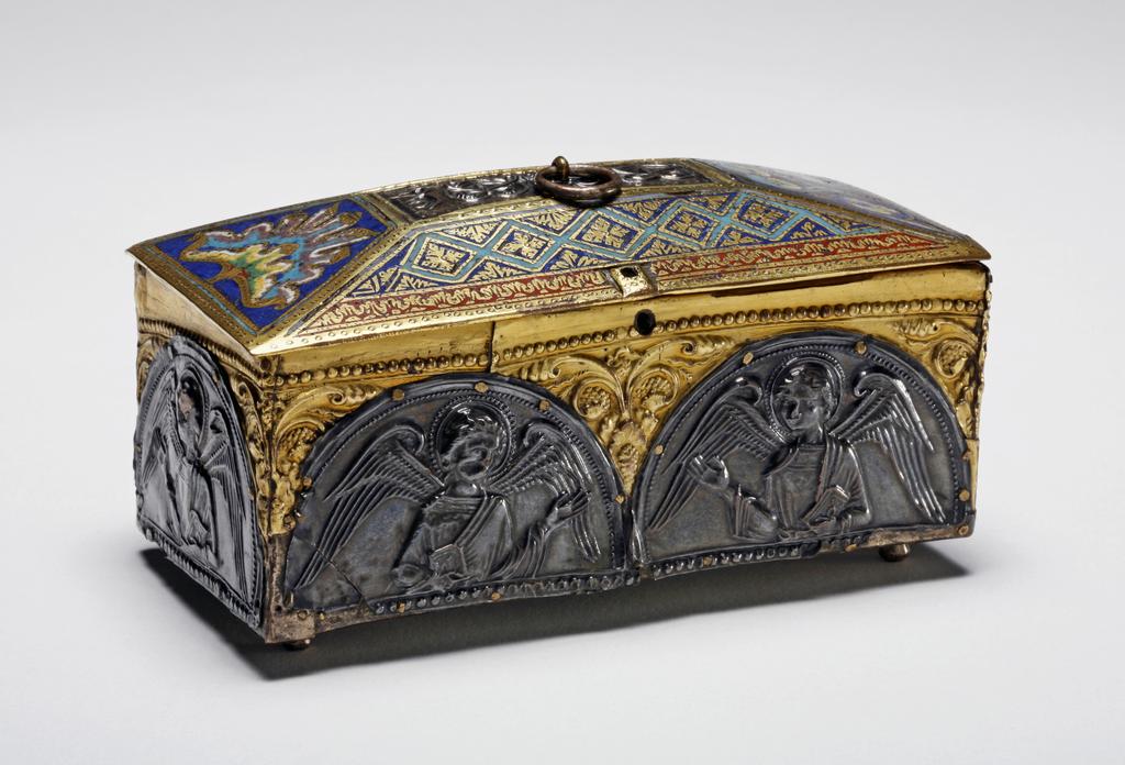 An image of Casket. Unknown maker, England. Unknown maker, Meuse, Mosan. Rectangular with a lid of truncated pyramidal form. The sides are overlaid with thin D-shaped plates of silver embossed with figures of angels; the spandrels have embossed vine scrolls in gold. Along the top of the lid there is a strip of silver embossed with palmettes, the rest is covered with champlevé enamel. Copper, engraved, champlevé, enamelled, and gilded, with applied repoussé silver plaques, the box interior of wood, height, whole, 5.7 cm, width, whole, 11 cm, depth, whole, 5.8 cm, circa 1170-1200. Enamels late 12th century; plaques c. 1170; wooden interior modern (date uncertain). Romanesque.