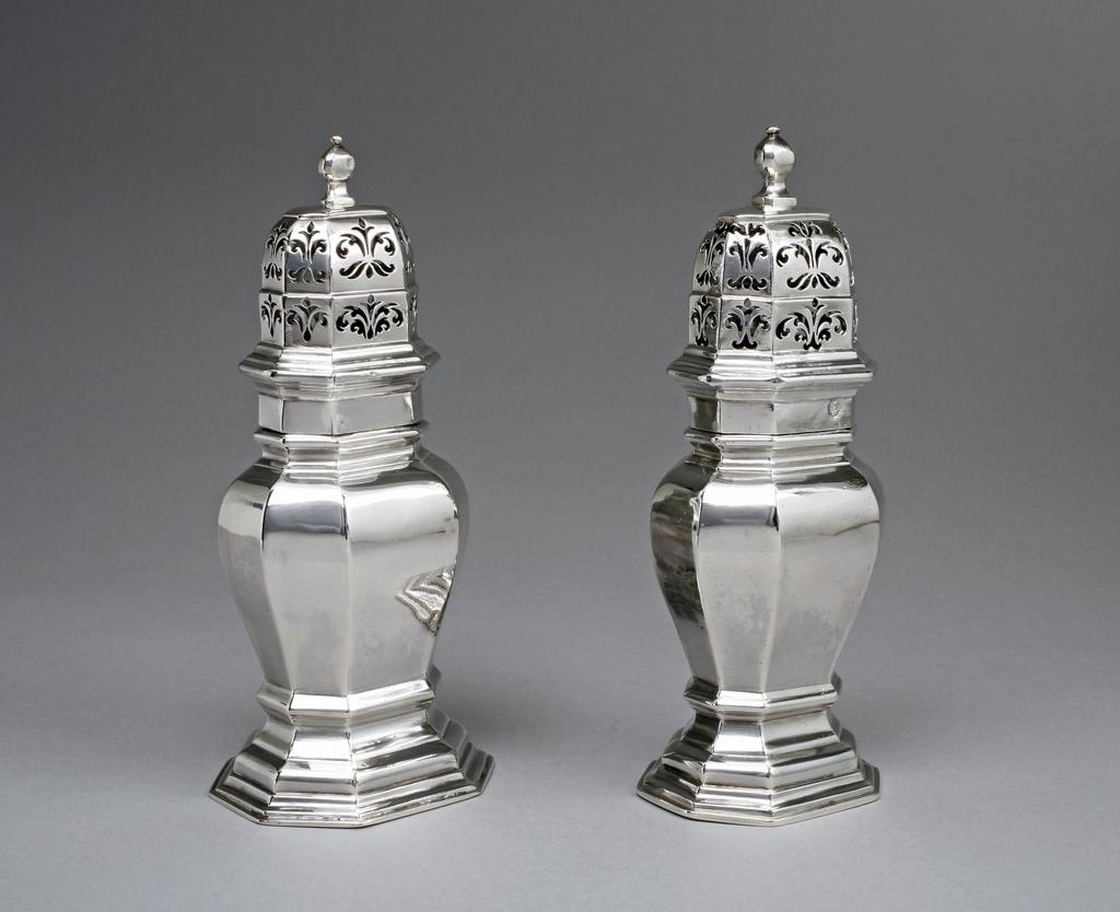 An image of Pair of silver casters with pierced covers.