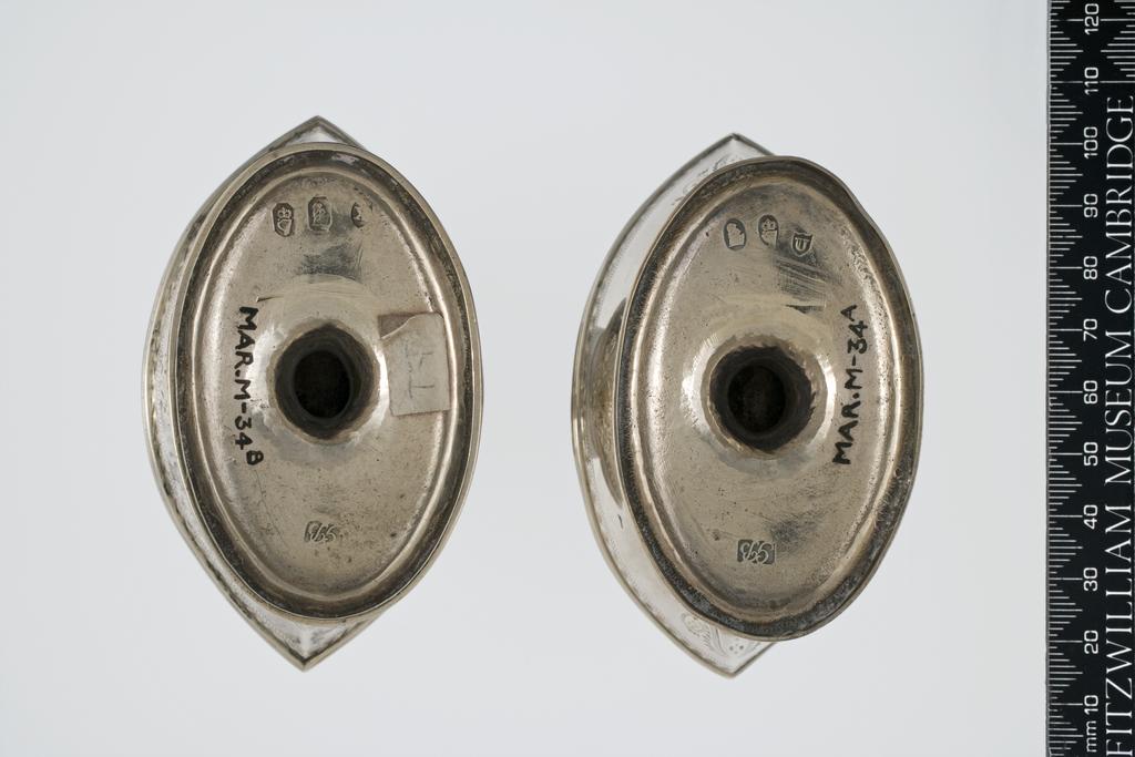 An image of BRYNE, Gust'v'sSilver salt cellarssilver; navette-shaped; the sides with reeded rim and bright cut engraved border above swags and two navette-shaped catrouches, one containing a crest; standing on a narrow pedestal on an oval foot decorated with a bright cut engraved border and reeded foot mountC.1792-3Dublin, Ireland