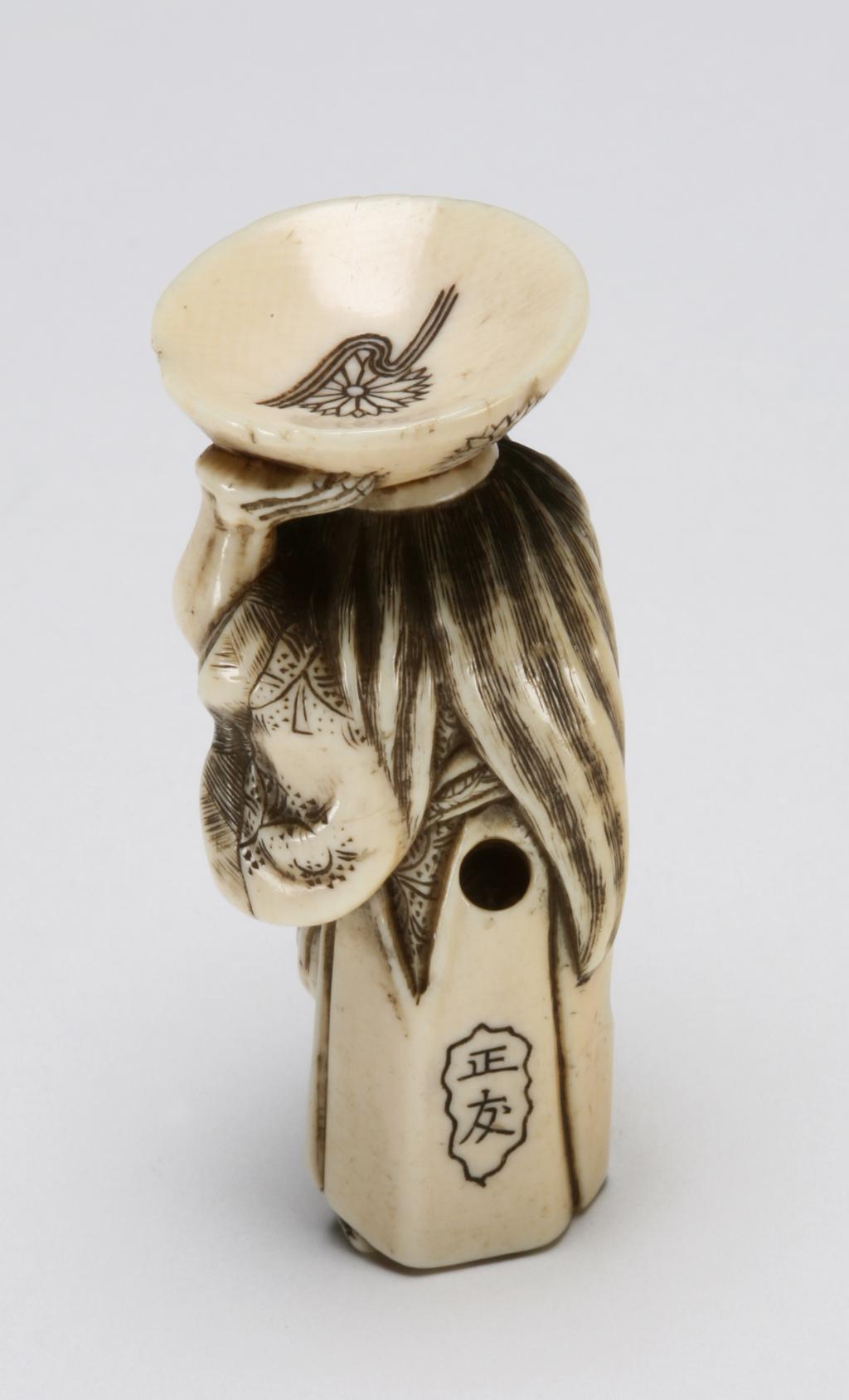 An image of Netsuke. A Shōjō, mythical creature addicted to alcohol, with long hair and a sake cup on its head. Shōyu (Japanese). Ivory, with incised and stained detail, height 5.5 cm. Acquisition Credit: Marlay Bequest.