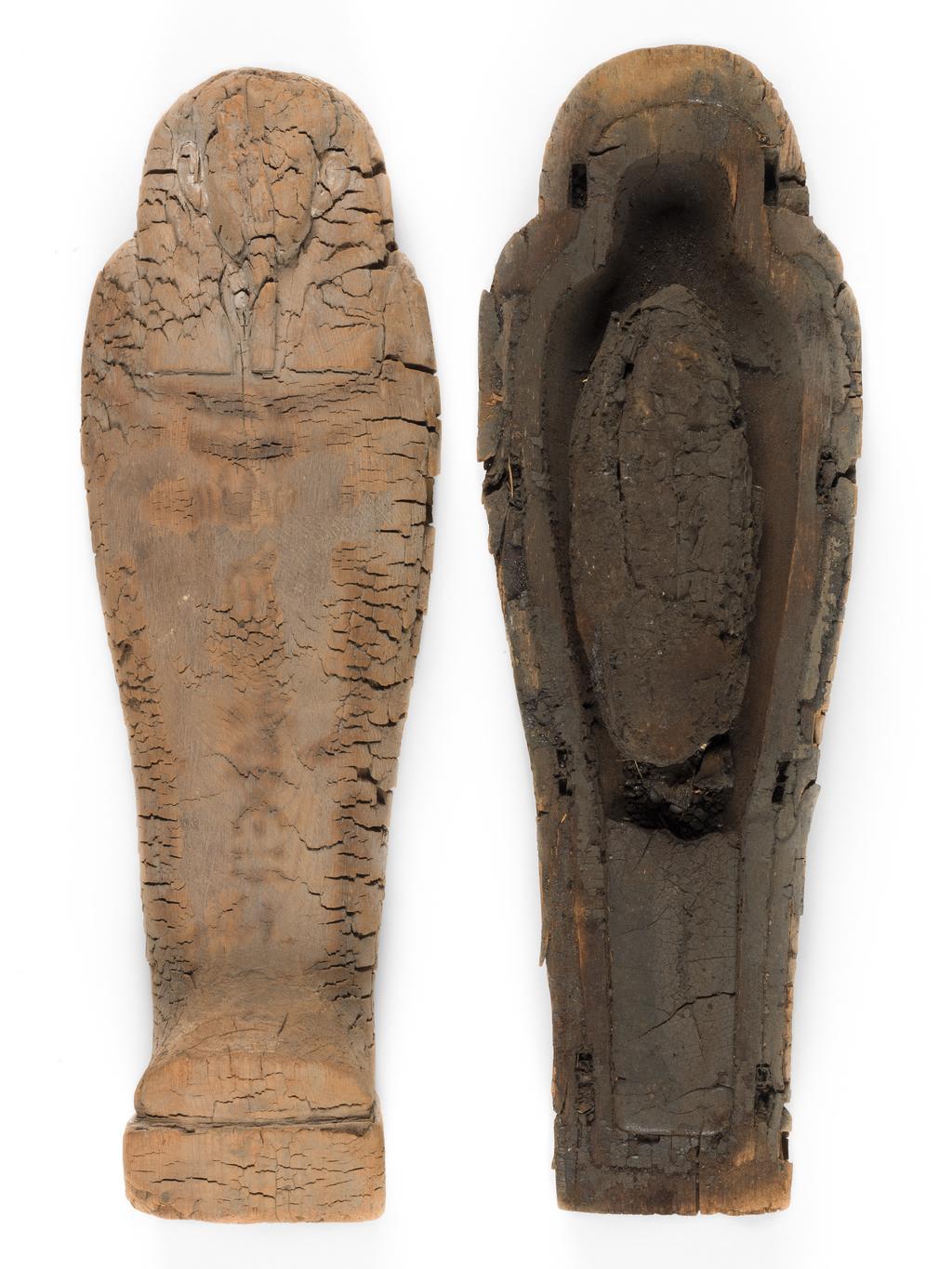 An image of Funerary Equipment. Coffin. Miniature coffin, with embalmed object, possibly the body of an infant, coated in pitch inside. Production Place: Egypt. Find Spot: Gizeh, Egypt. Wood, length 43.8 cm, width 13.4 cm, depth 14.1 cm, circa 664- circa 525 B.C. Dating not confident. Late Period.