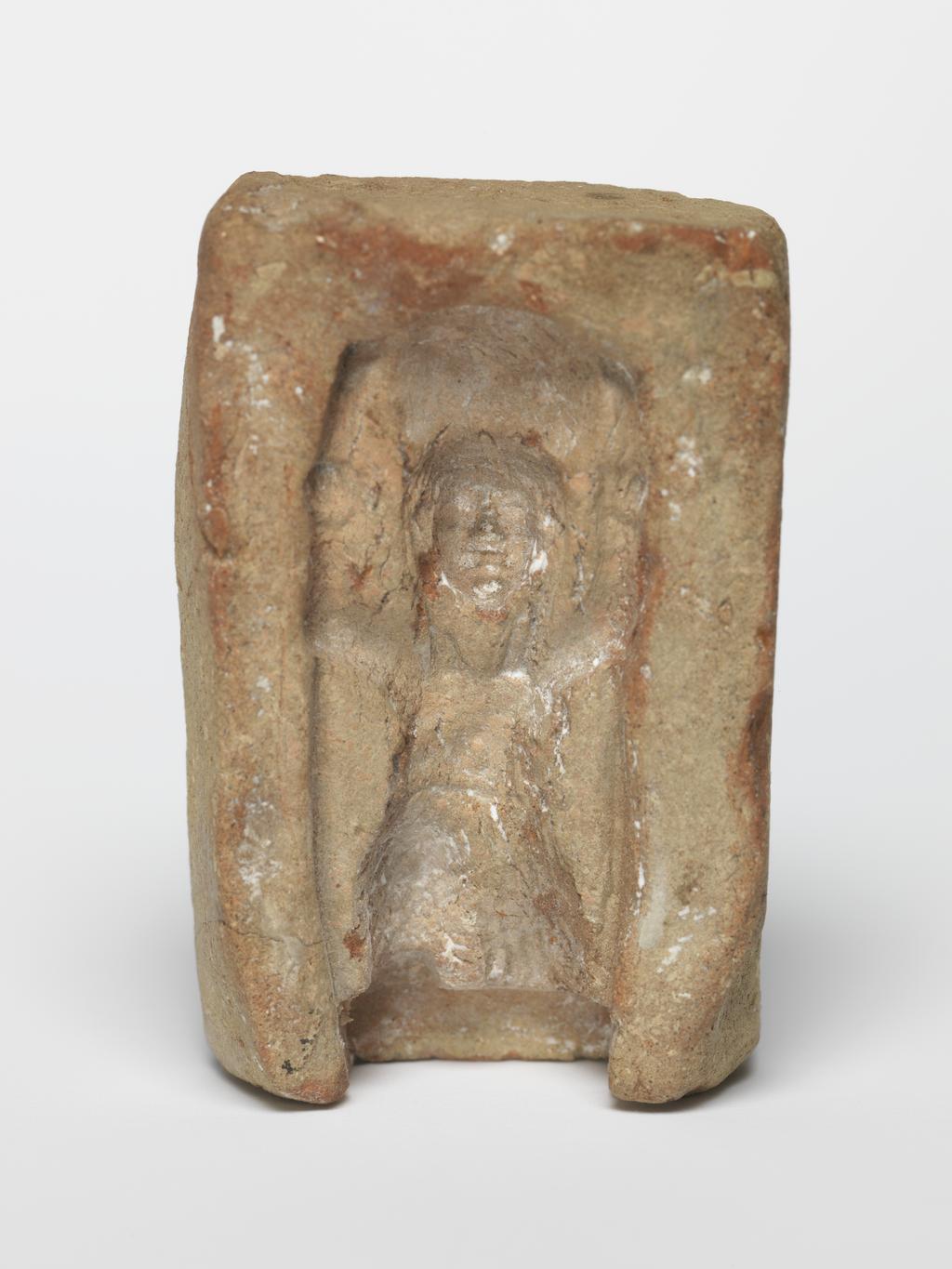 An image of Equipment/Mould. Shu, kneeling, holding sun disk above head. Production Place/Find Spot: Egypt. Length, design, 0.038 m.
